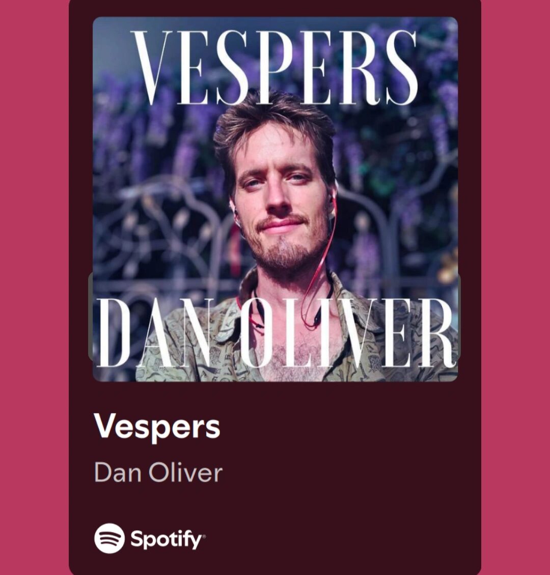 Album cover with a man with short hair and beard, background of purple flowers, text 'Vespers' and 'Dan Oliver'.