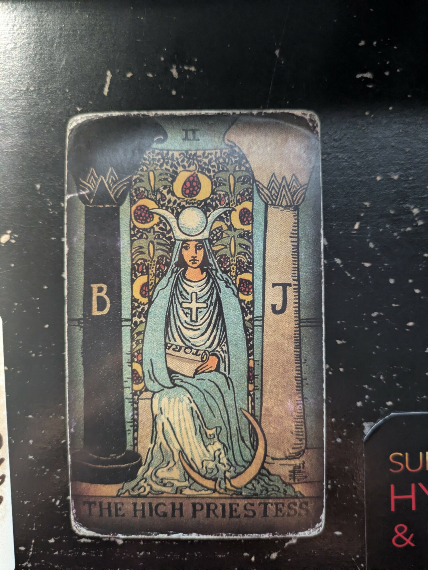 Tarot card titled 'The High Priestess' features a seated woman with a crown, holding a scroll, between two pillars labeled B and J.