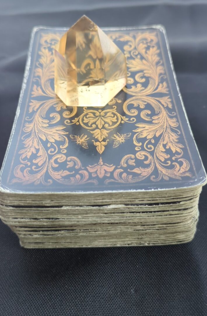 A clear, faceted gemstone on an ornate, decorative box with gold and blue patterns.