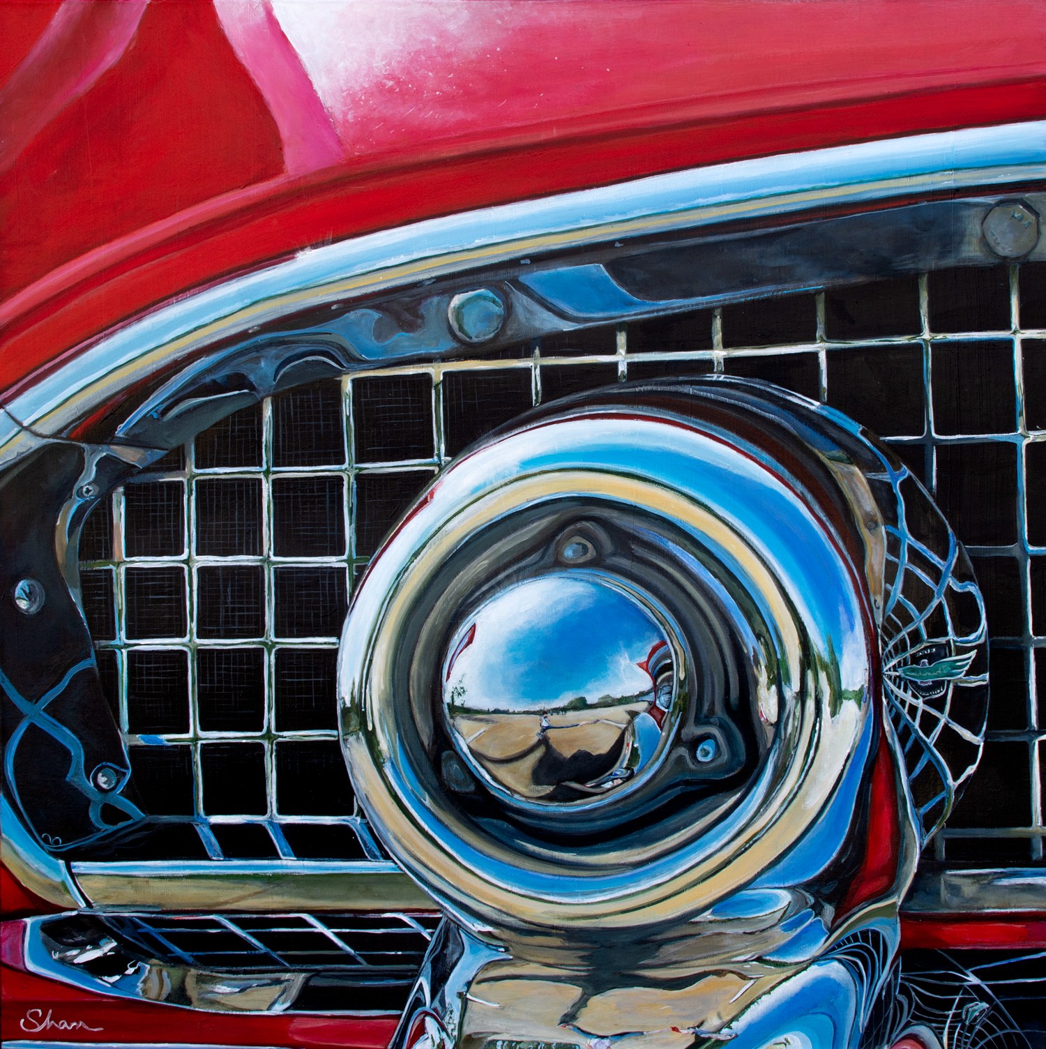 Close-up of a shiny chrome car headlight and grille with reflections of the sky and surroundings.