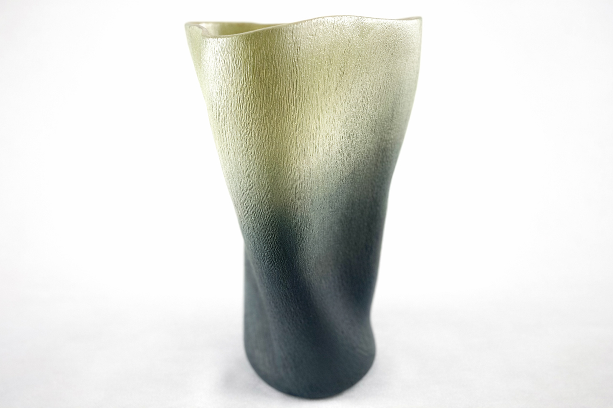 Tall ceramic vase with a gradient color from light green at the top to dark blue at the bottom.