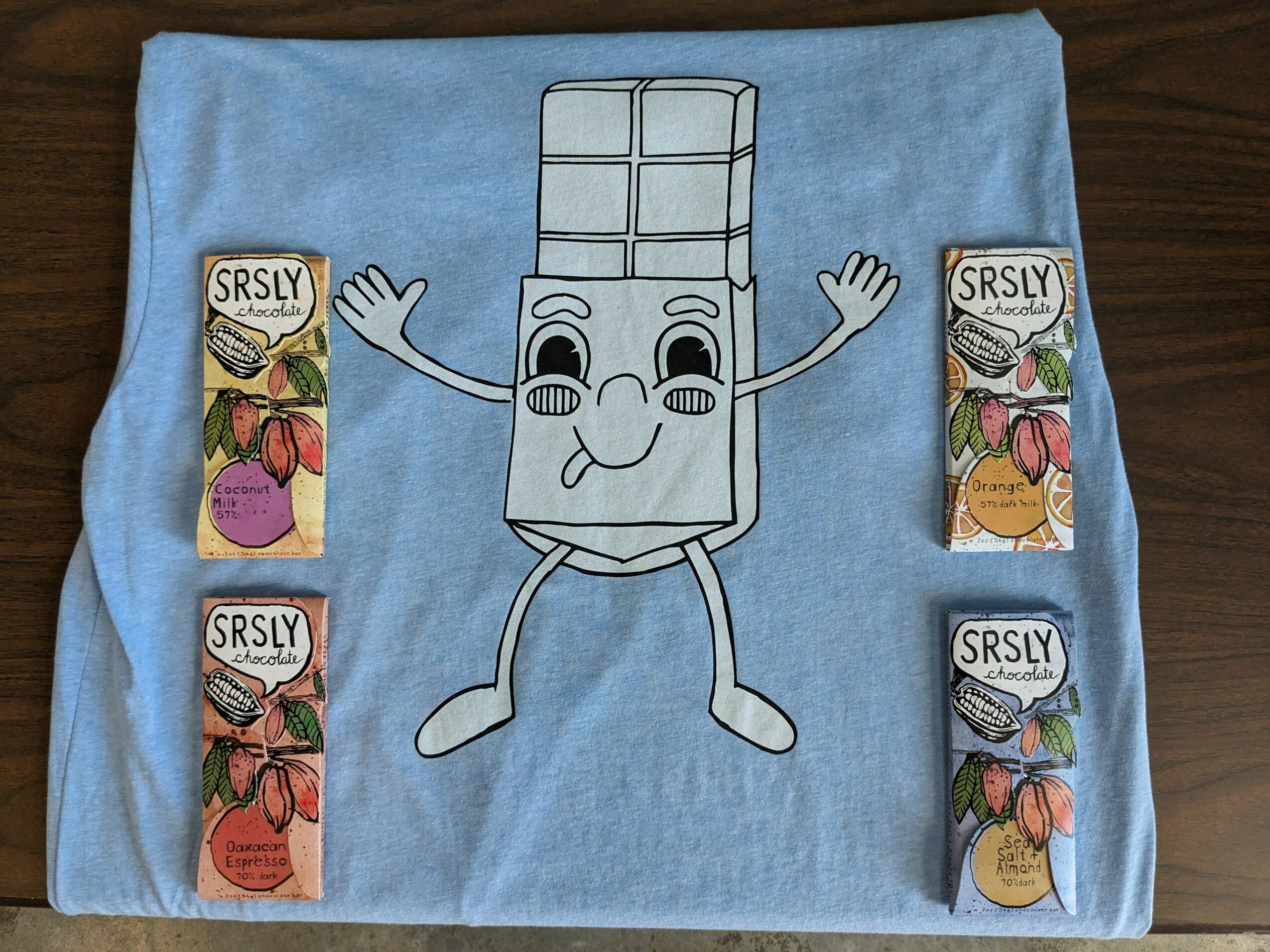 Blue cloth with a cartoon character resembling a tissue box with arms, legs, and a face, smiling and waving.