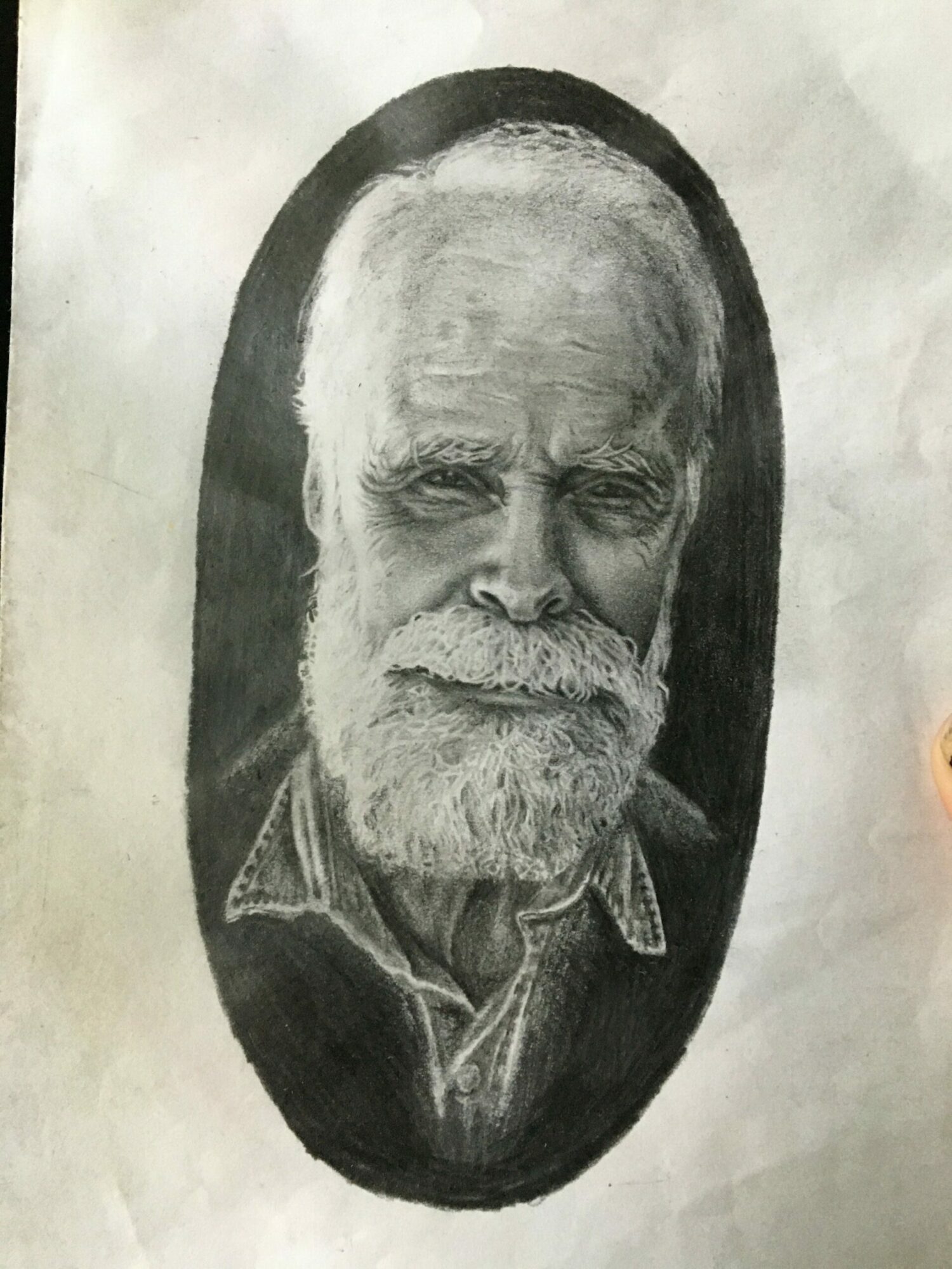 Black and white portrait of an elderly man with a beard, inside an oval frame.