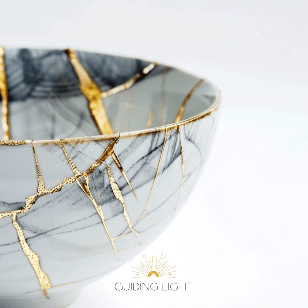 Close-up of a gray and white marbled bowl with gold veining, against a white background.