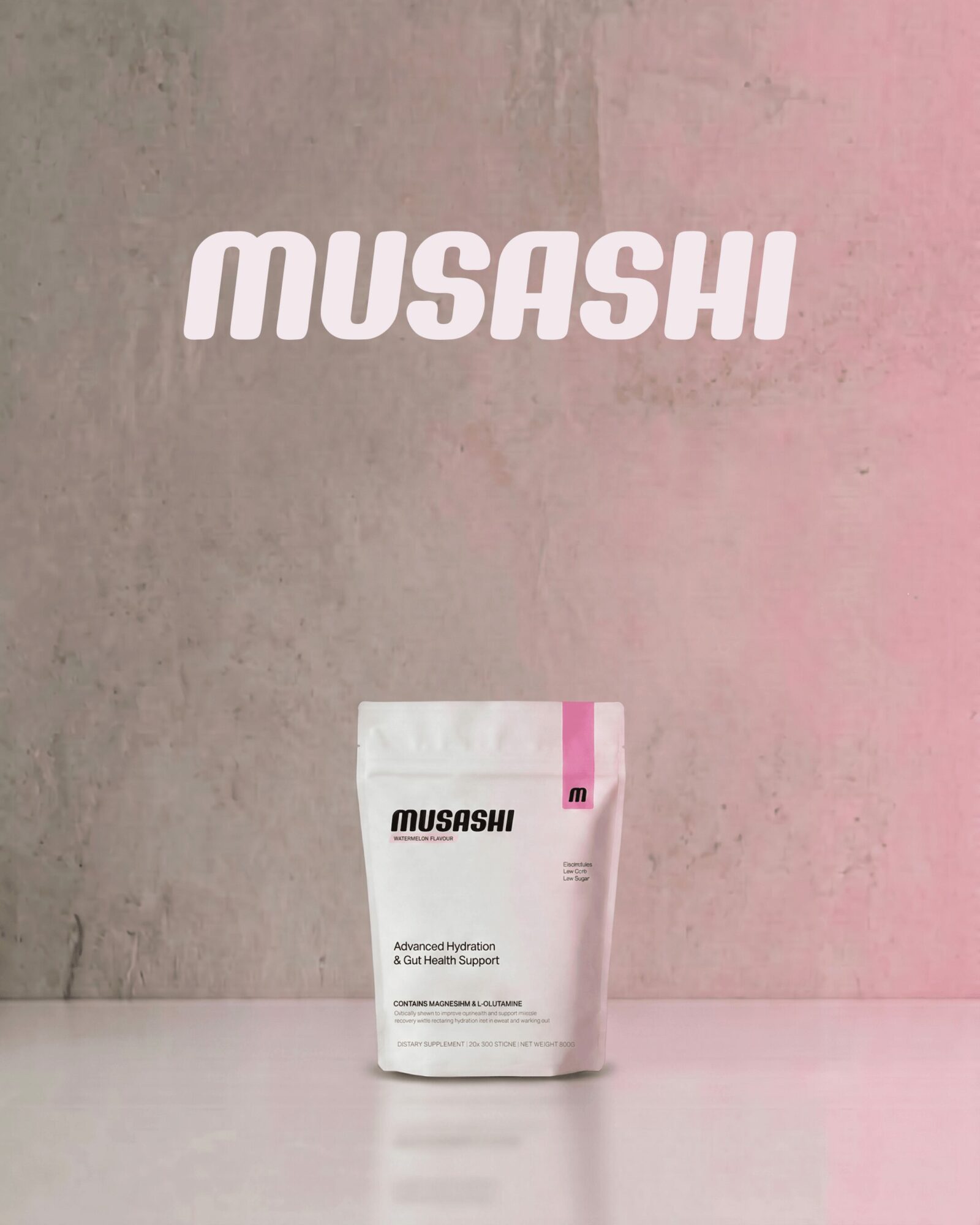 A white package with pink accents stands on a surface against a pink and gray background, with the word 'MUSASHI' above.