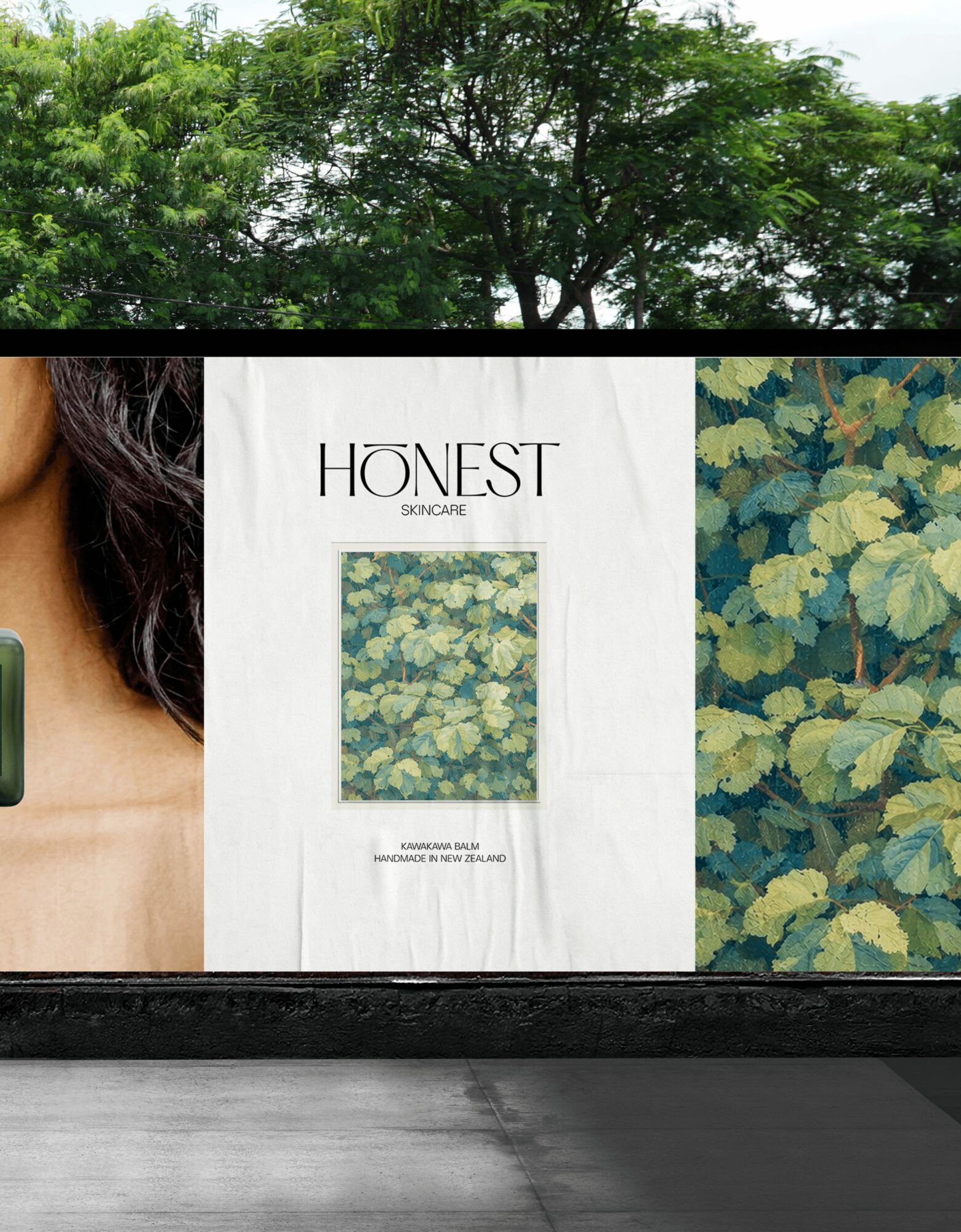 Tree with green leaves against sky, advertisement with text 'HONEST' and floral pattern, and part of a person's shoulder and hair.
