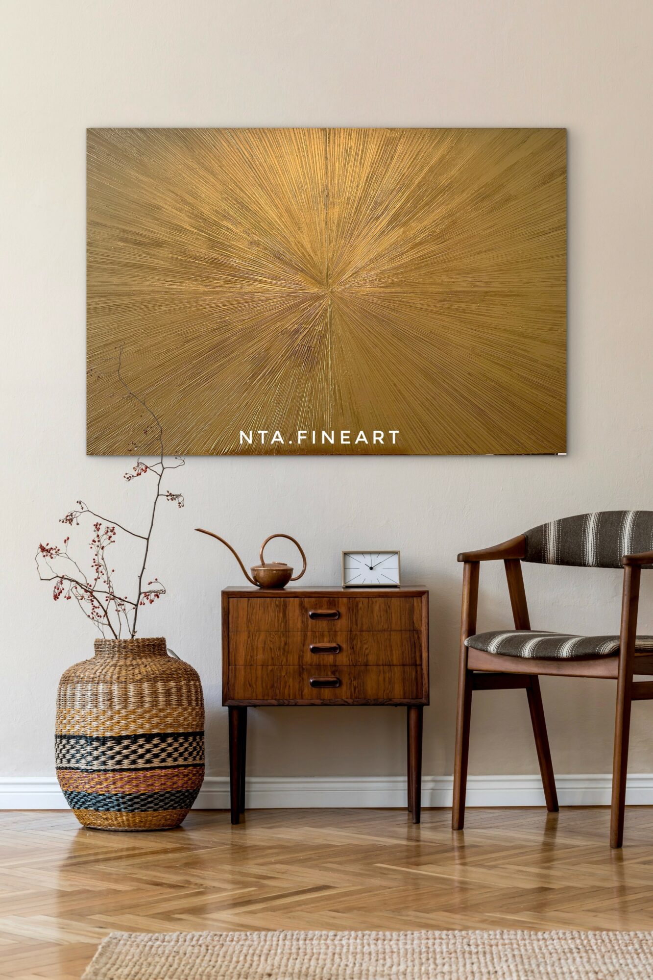 Wall with large abstract gold artwork, wooden side table, woven vase with branches, and a wooden chair with striped cushion.