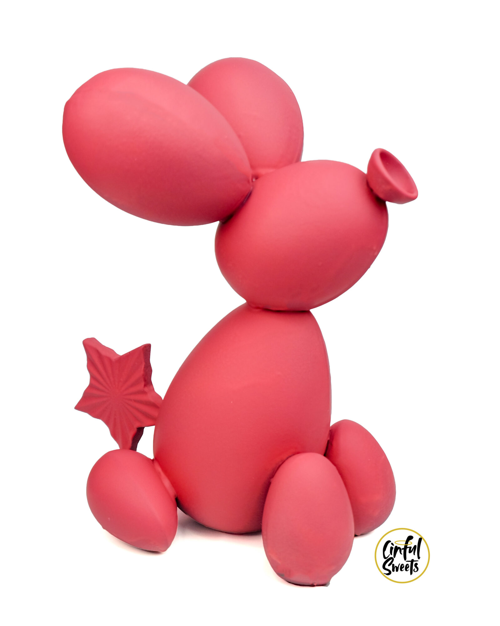 Pink balloon animal resembling a mouse with large ears, a tail, and a small nose, on a white background.