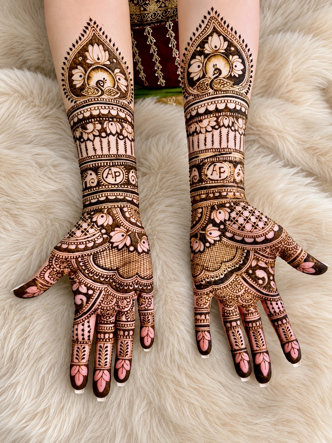 Intricate henna designs on hands and forearms, with floral and geometric patterns, on a furry background.