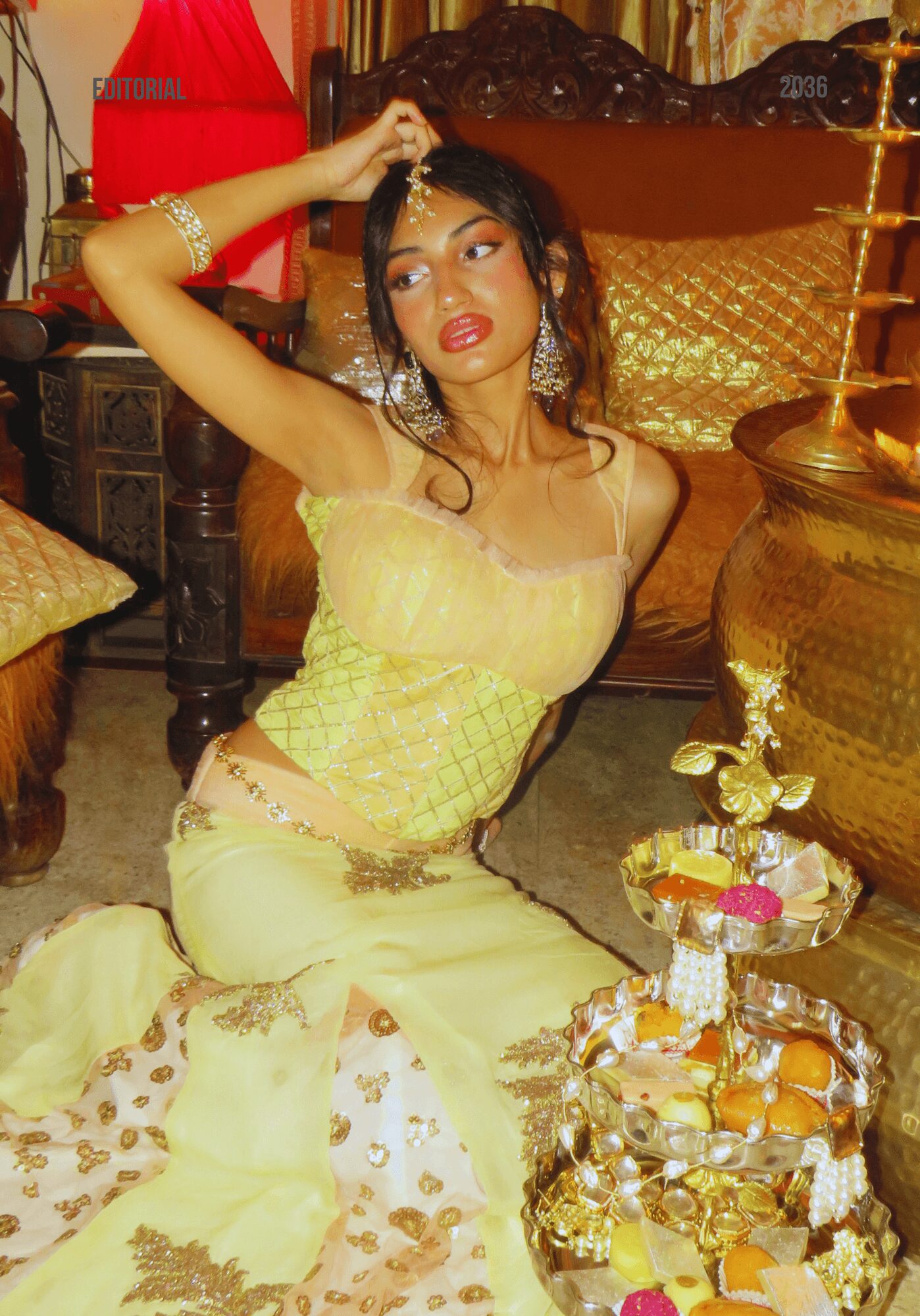 Young woman in yellow dress sitting on the floor, holding her hair, surrounded by ornate furniture and decorations.