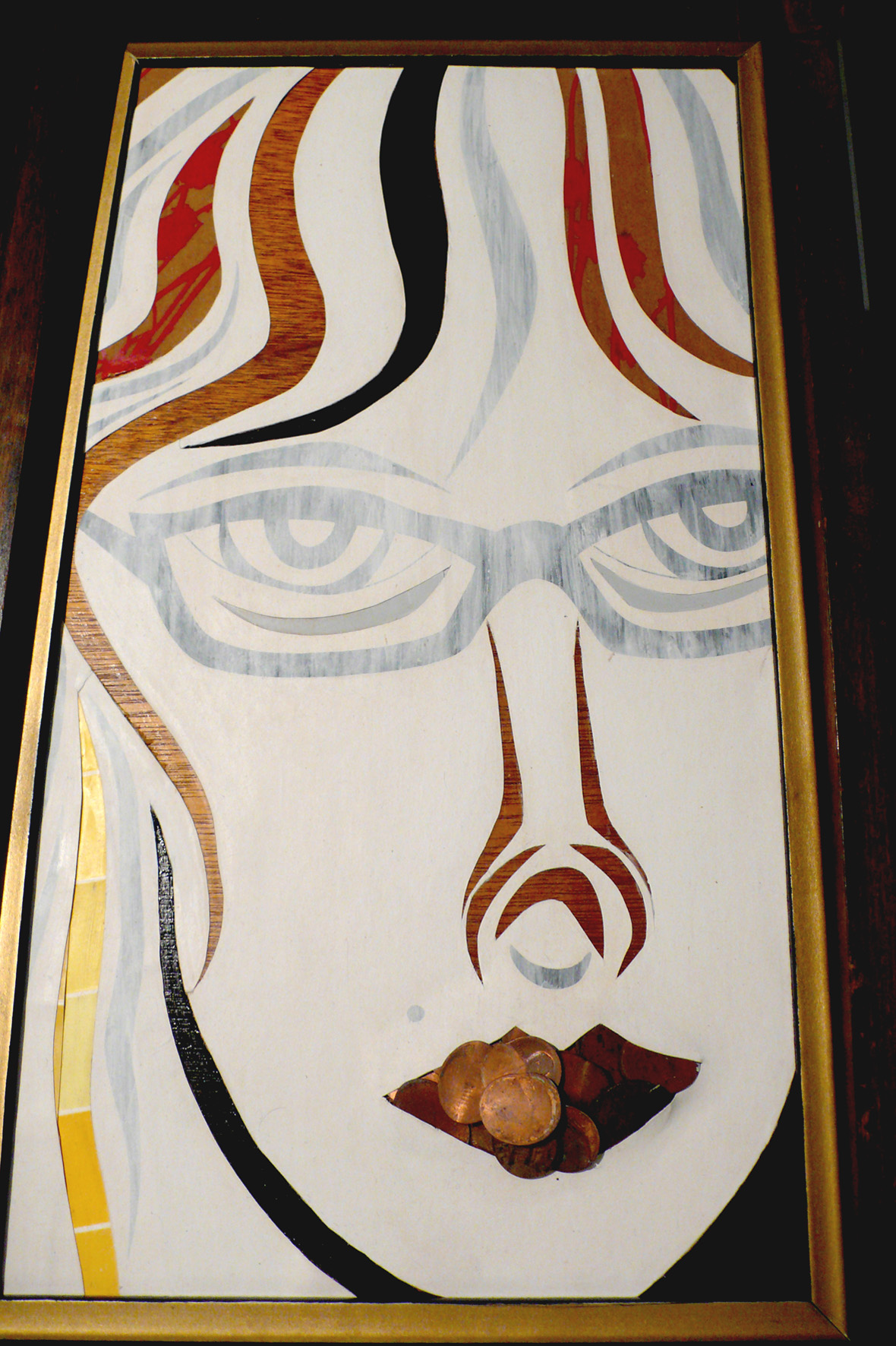 Abstract portrait of a face with glasses, red and black hair, and a brown object on the lips, framed and upright.