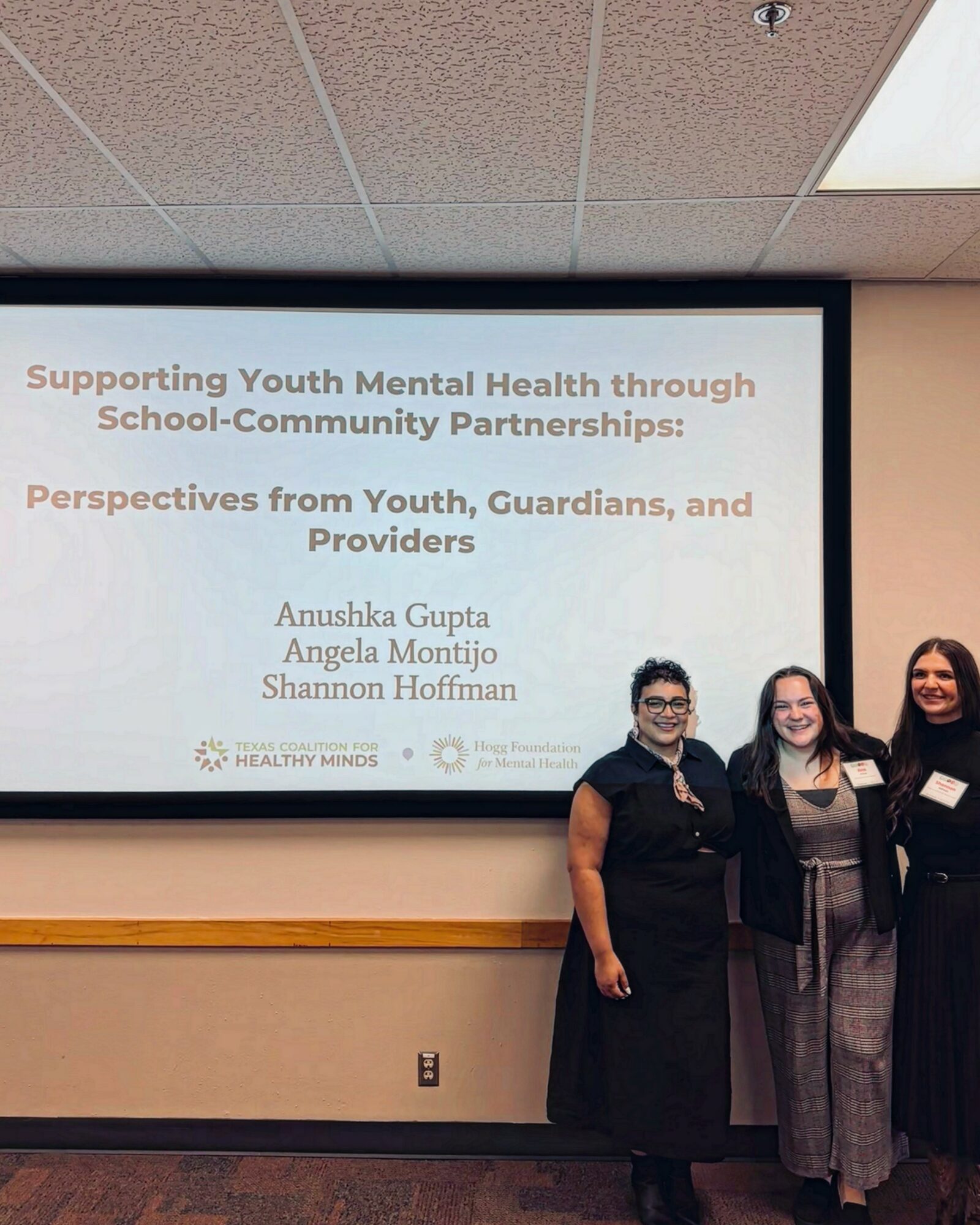 Presentation slide titled 'Supporting Youth Mental Health through School-Community Partnerships' with three speakers standing in front.