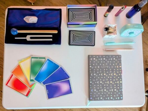 Desk with colorful cards, notebooks, pens, and office supplies arranged neatly.