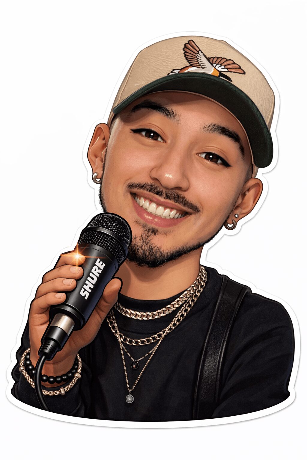 Young man smiling, holding a microphone, wearing a beige cap with a butterfly, black shirt, and layered necklaces.