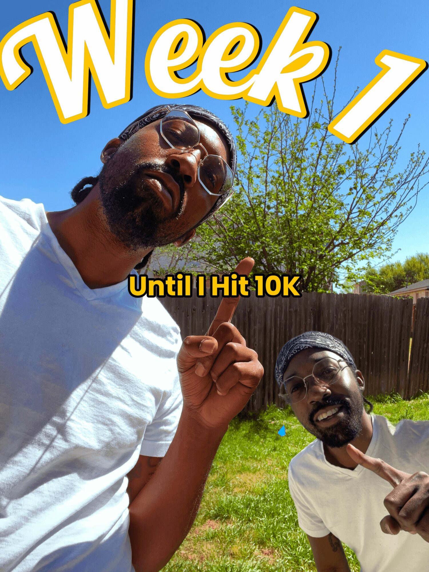 Two men outdoors with a tree and fence, one pointing upward, the other giving a thumbs-up, under a blue sky.