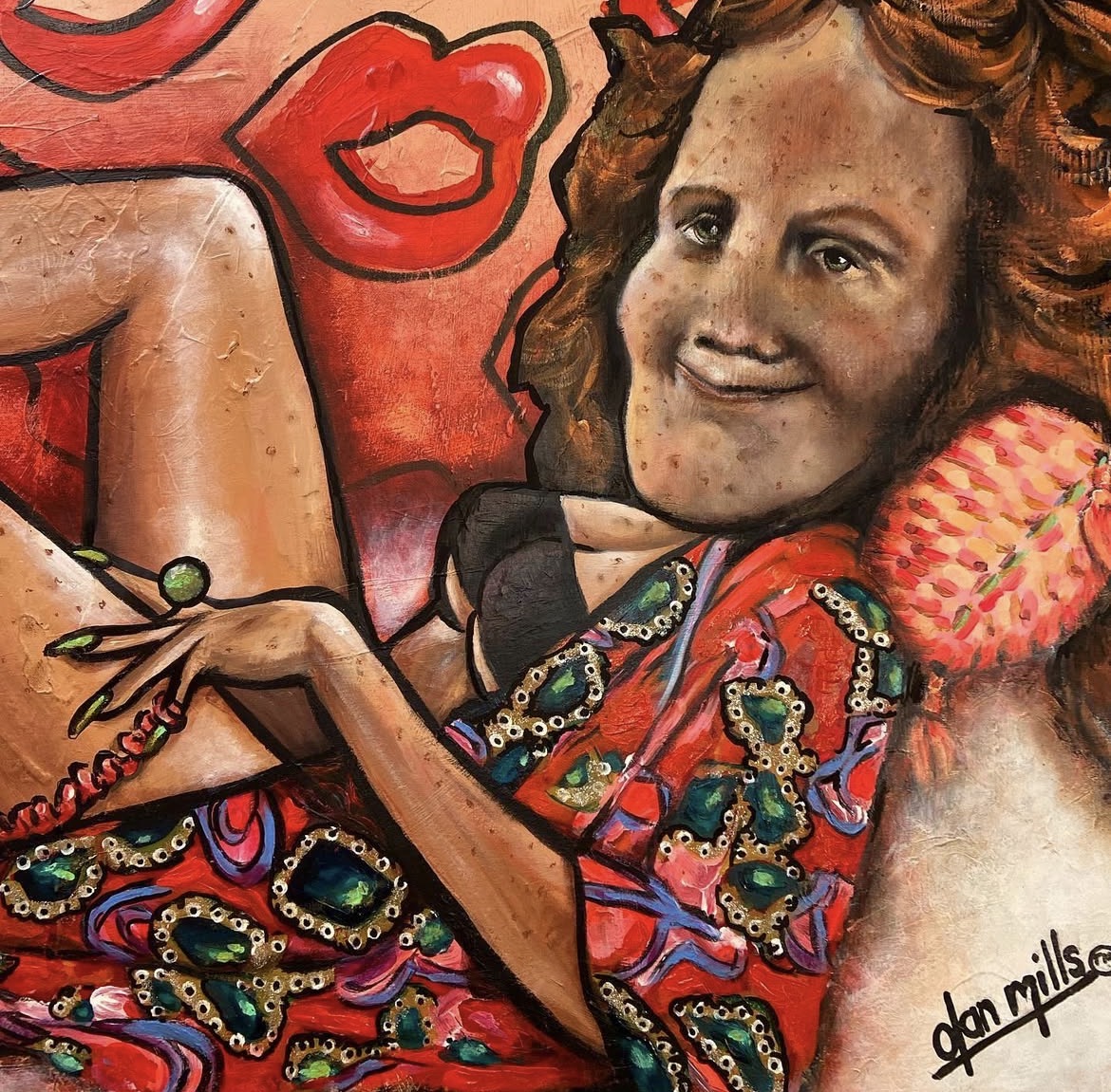 A woman with curly hair lying on a colorful patterned pillow, smiling, with a background of red lips and abstract shapes.