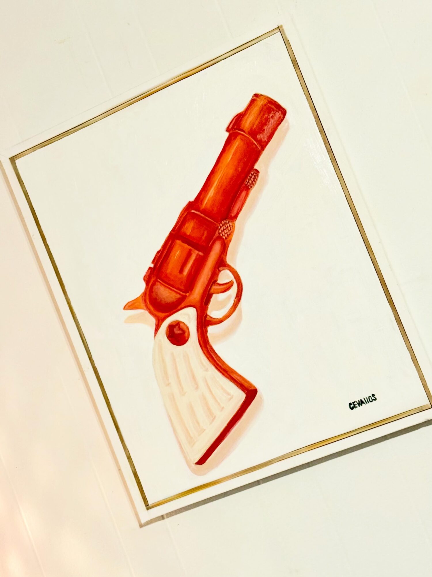 Illustration of a red toy gun with a white handle and a red button, on a white background.