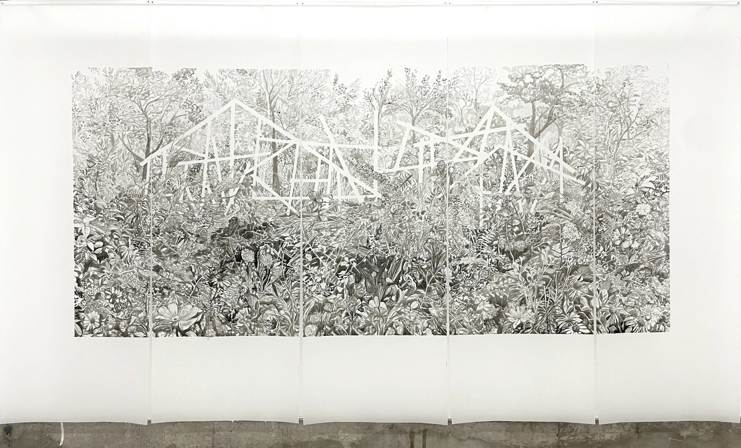 Black and white photo of a wooden structure in a wooded area, with trees in the background.