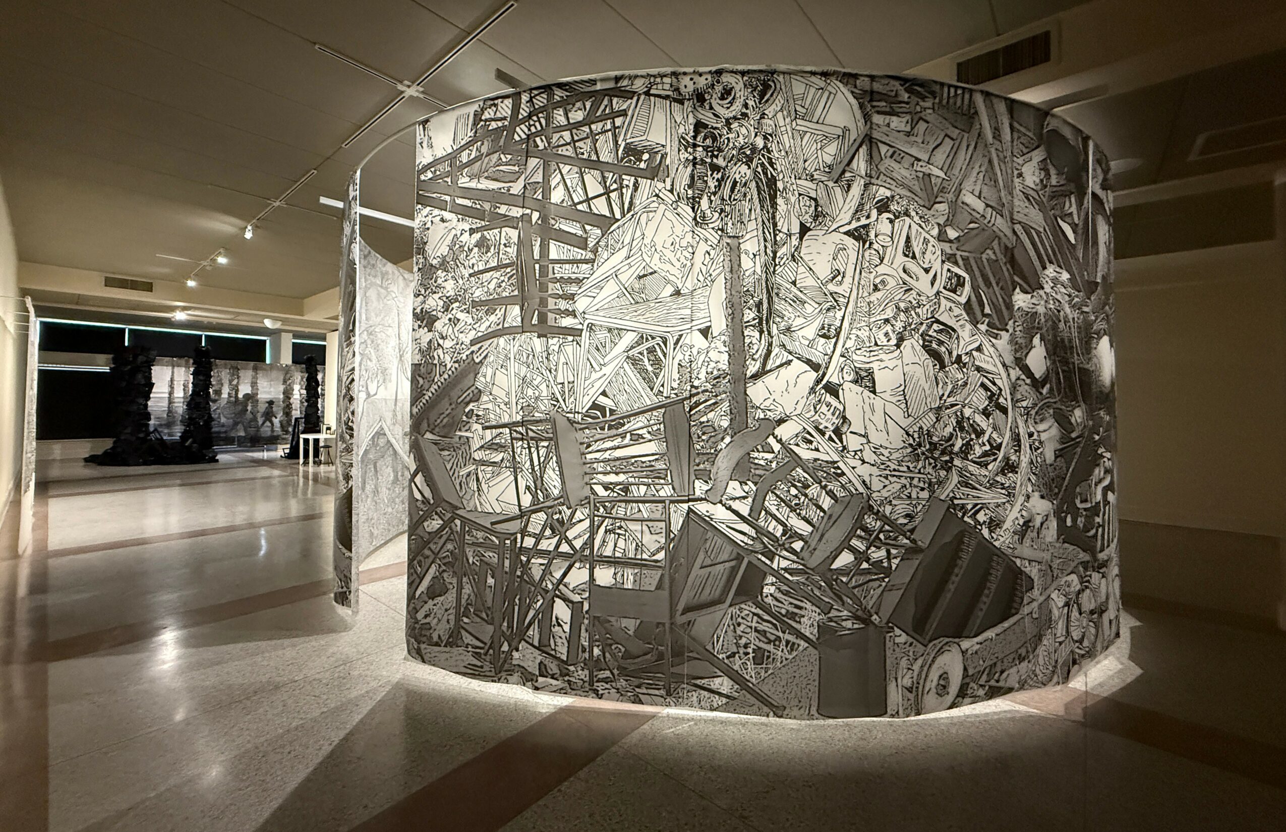 Curved wall with black and white abstract artwork in a modern indoor space.