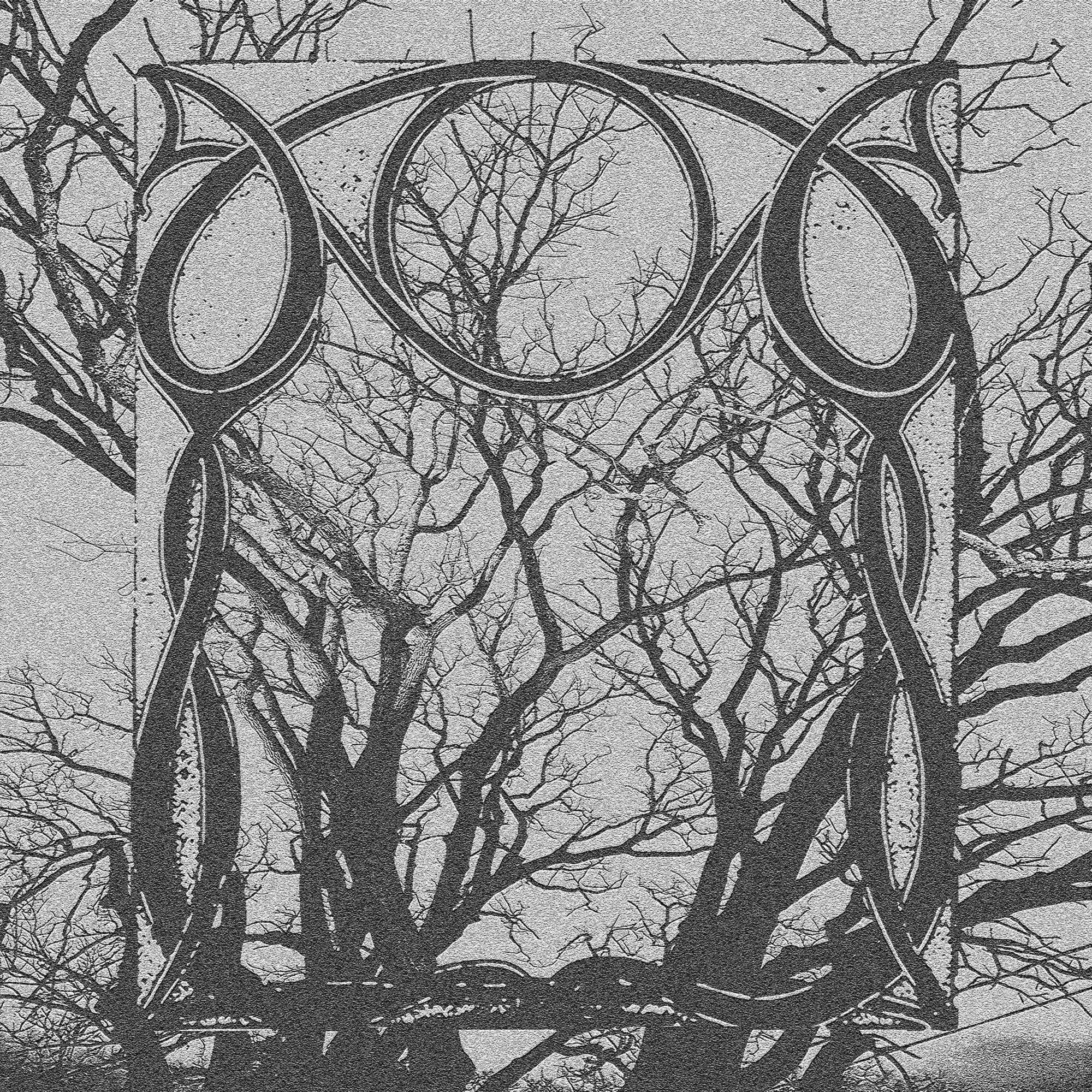 Tree branches visible through an ornate, decorative metal frame with leaf motifs, set against a cloudy sky.