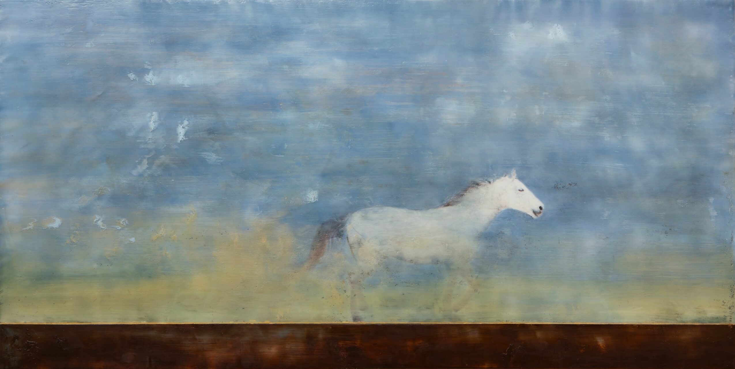 A white horse running through a misty landscape with a blue sky and a brown ground.