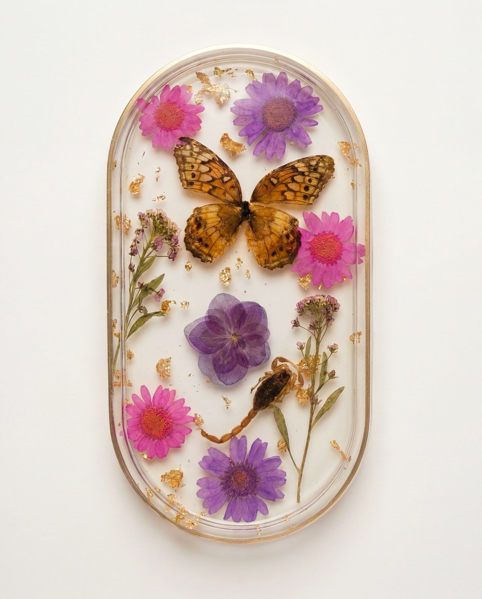 Butterfly surrounded by pink and purple flowers in a clear container, with dried plant material inside.