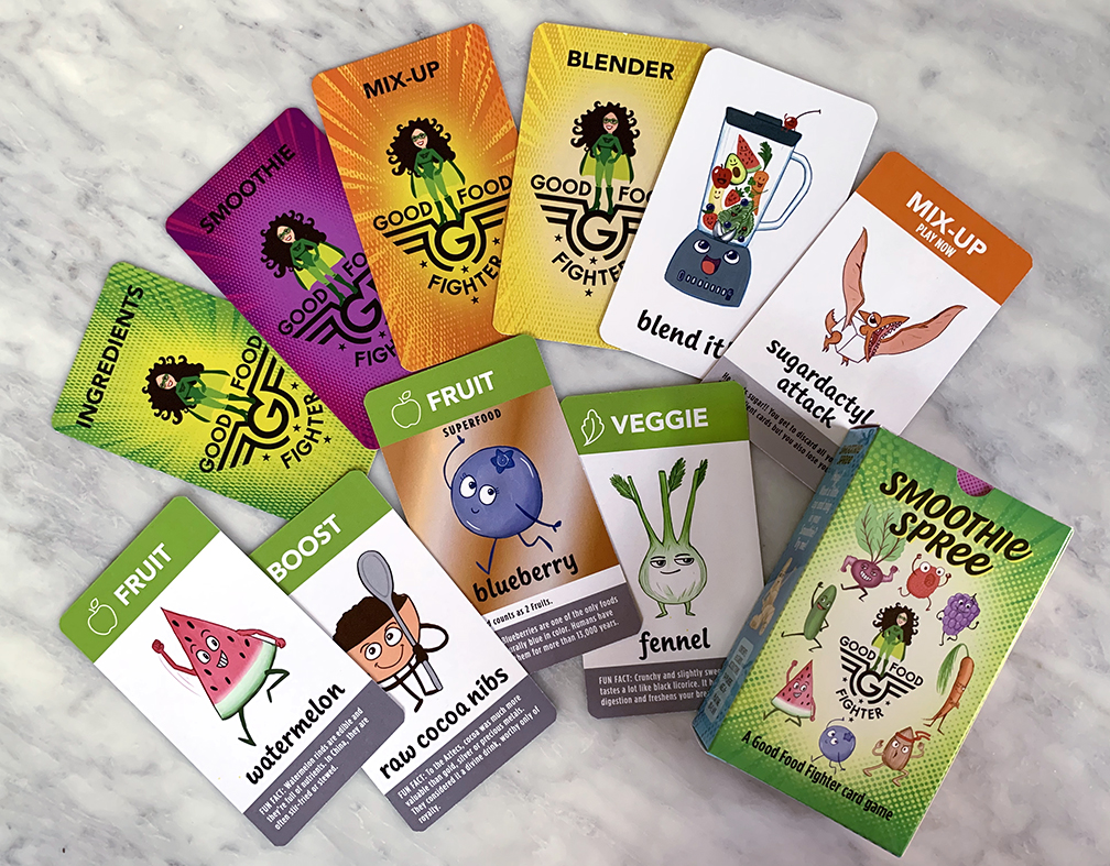 Collection of colorful cards with illustrations and text about food, smoothies, and ingredients, arranged on a marble surface.