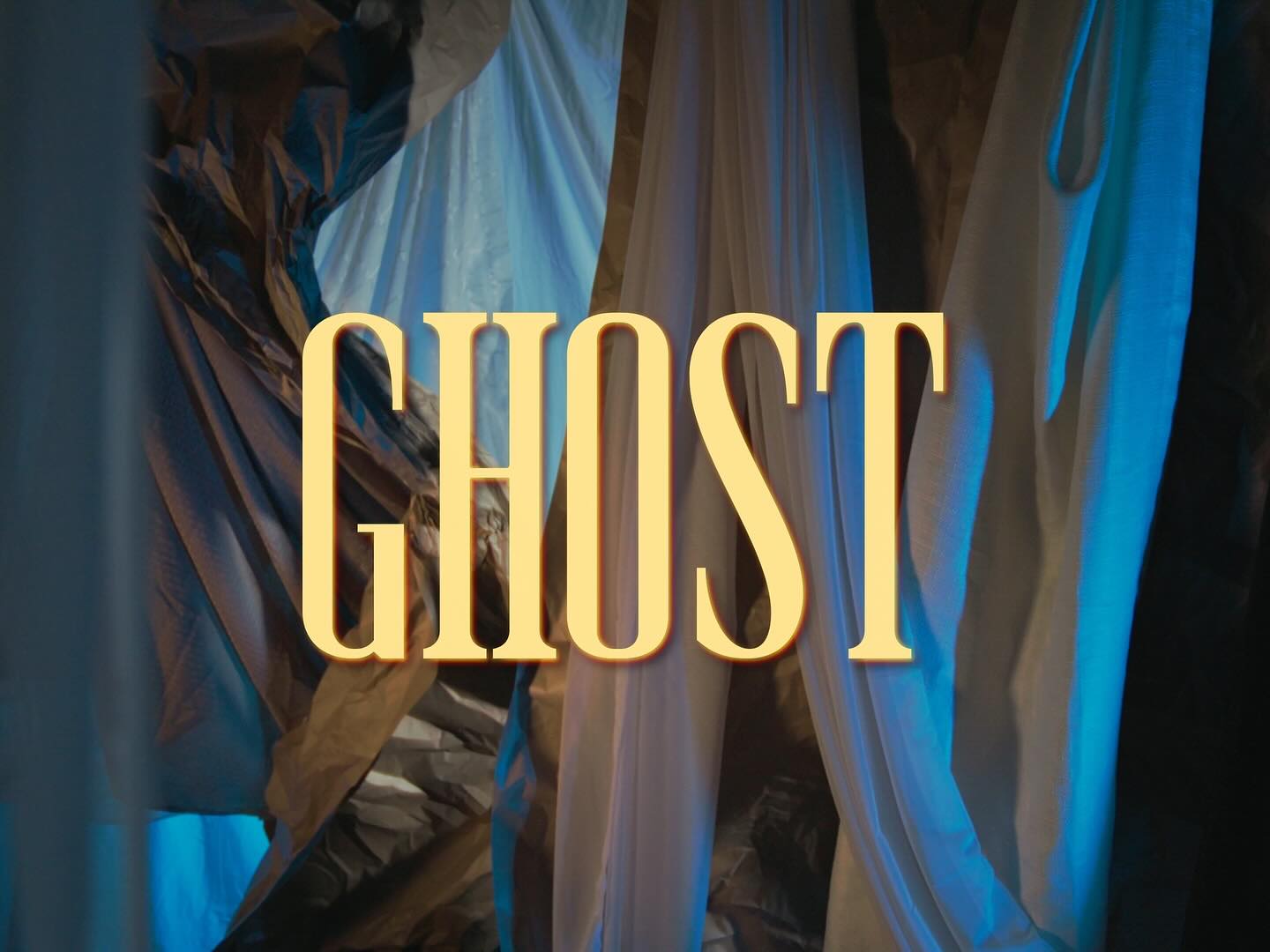 Curtains or drapes with blue and beige colors, with the word 'GHOST' in large yellow letters in the center.