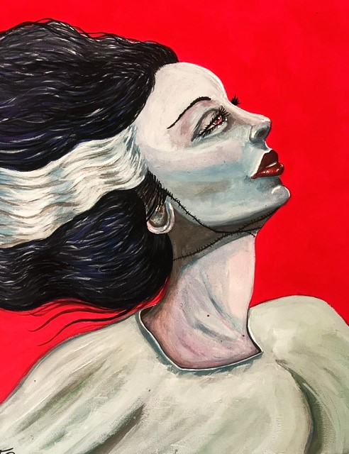 Portrait of a woman with flowing black and white hair, red lips, and a neutral expression against a red background.