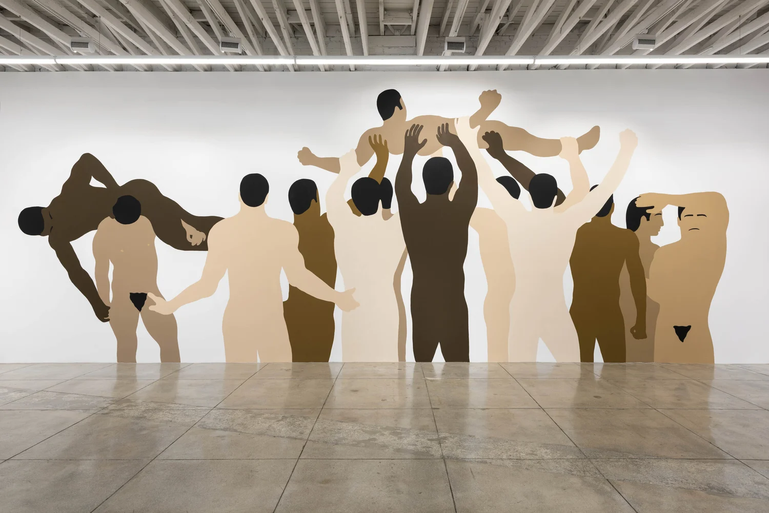 Wall mural depicting silhouettes of people in various poses, some holding hands, some lifting others, in neutral colors.
