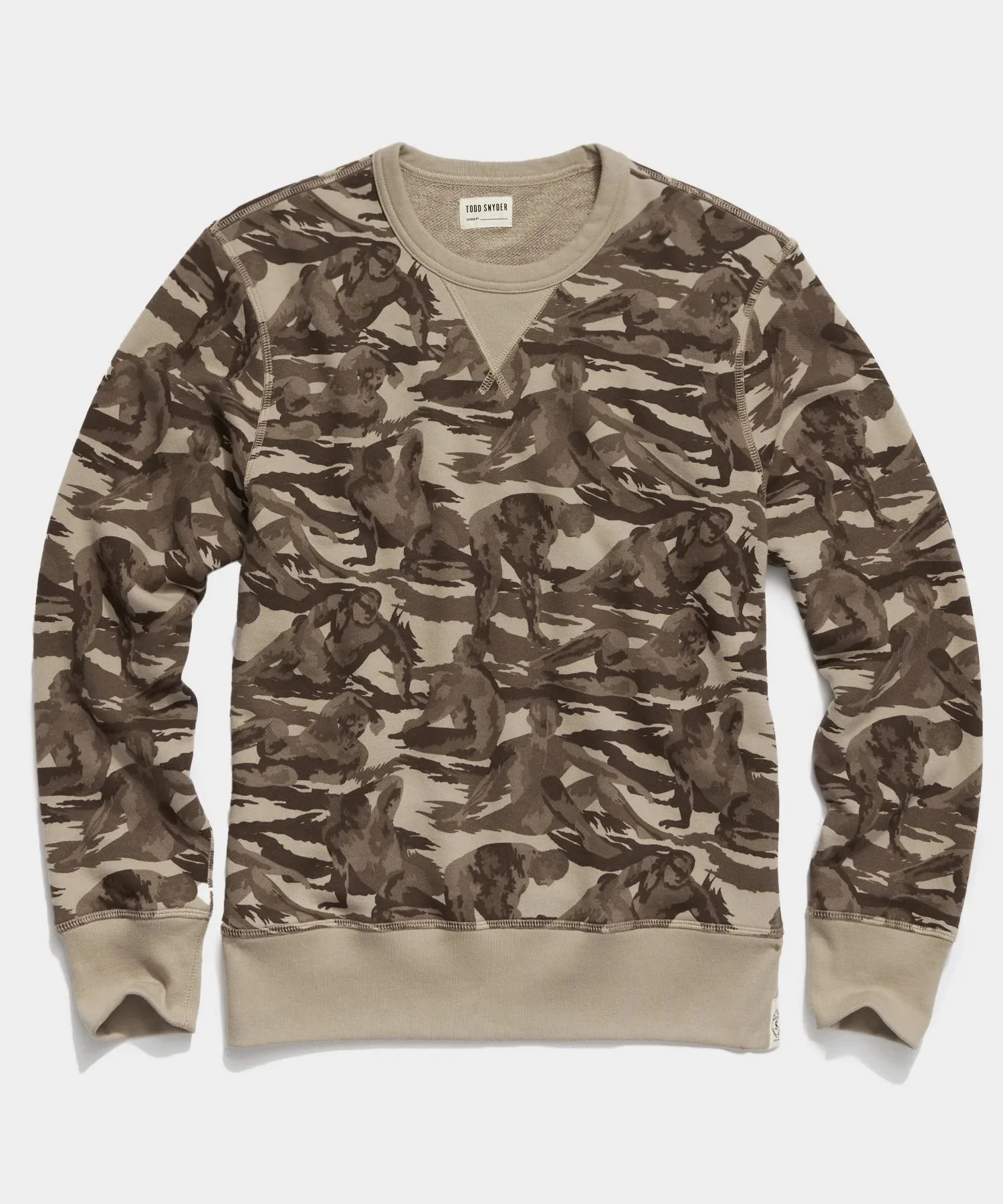 Camouflage patterned sweatshirt with beige cuffs and collar, long sleeves, and a crew neckline, laid flat.