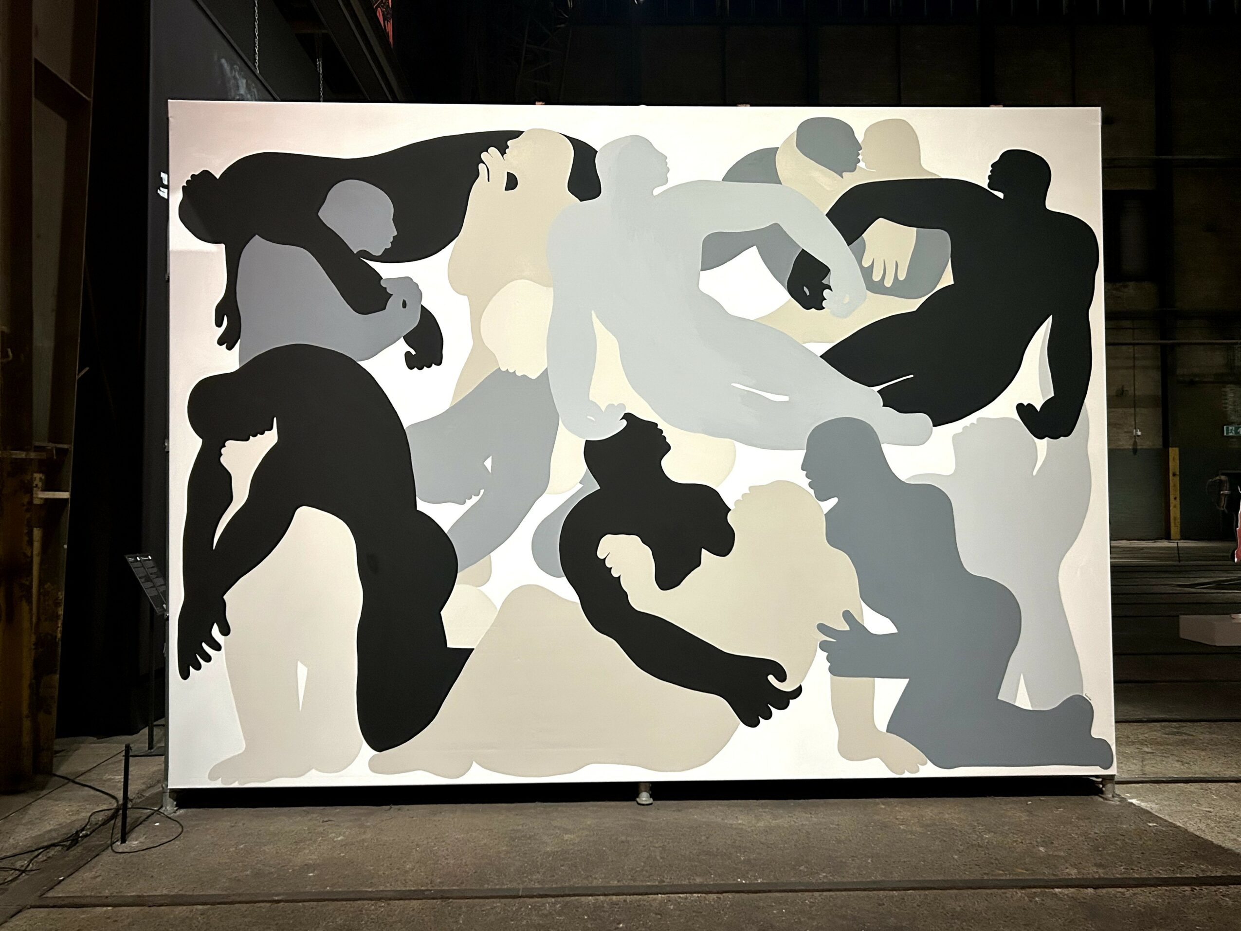 Abstract artwork with multiple human silhouettes in black, white, and gray, in various poses and interactions.