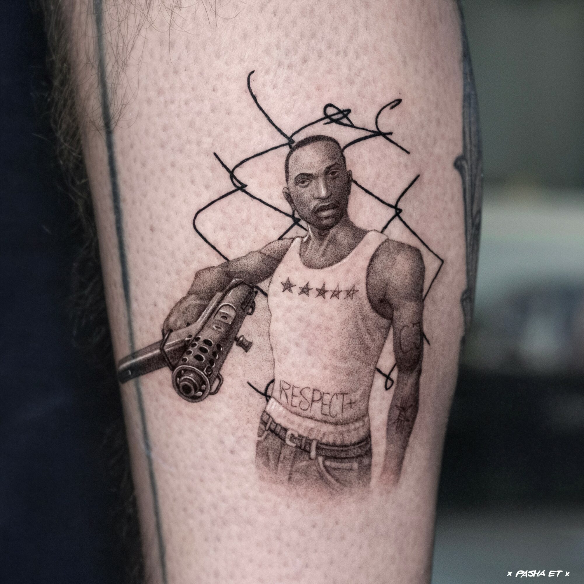 Tattoo of a man holding a gun, wearing a tank top with stars and the word 'RESPECT'.