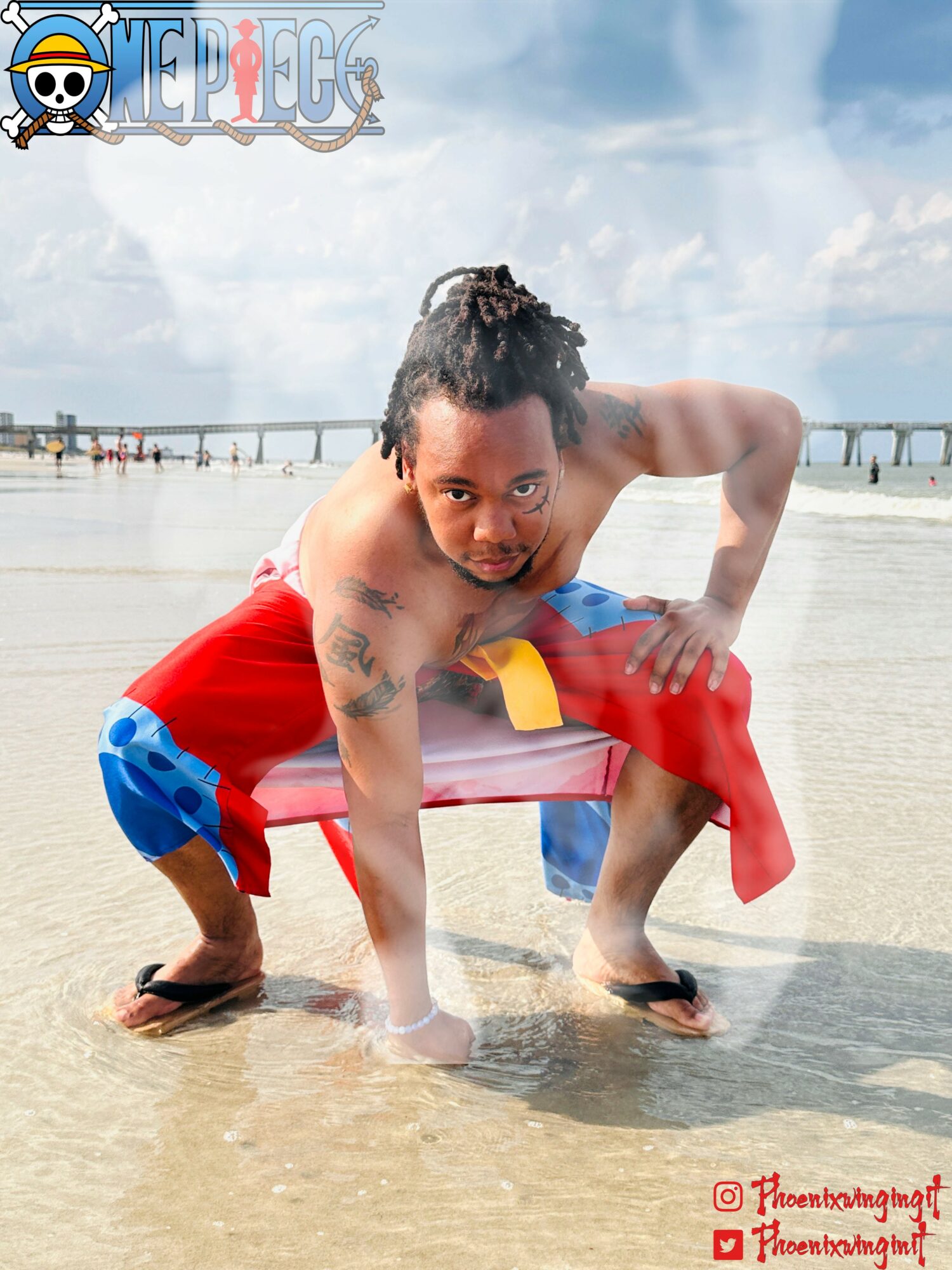 Child crouching on wet sand at the beach, wearing colorful shorts, with a pier in the background and cloudy sky.