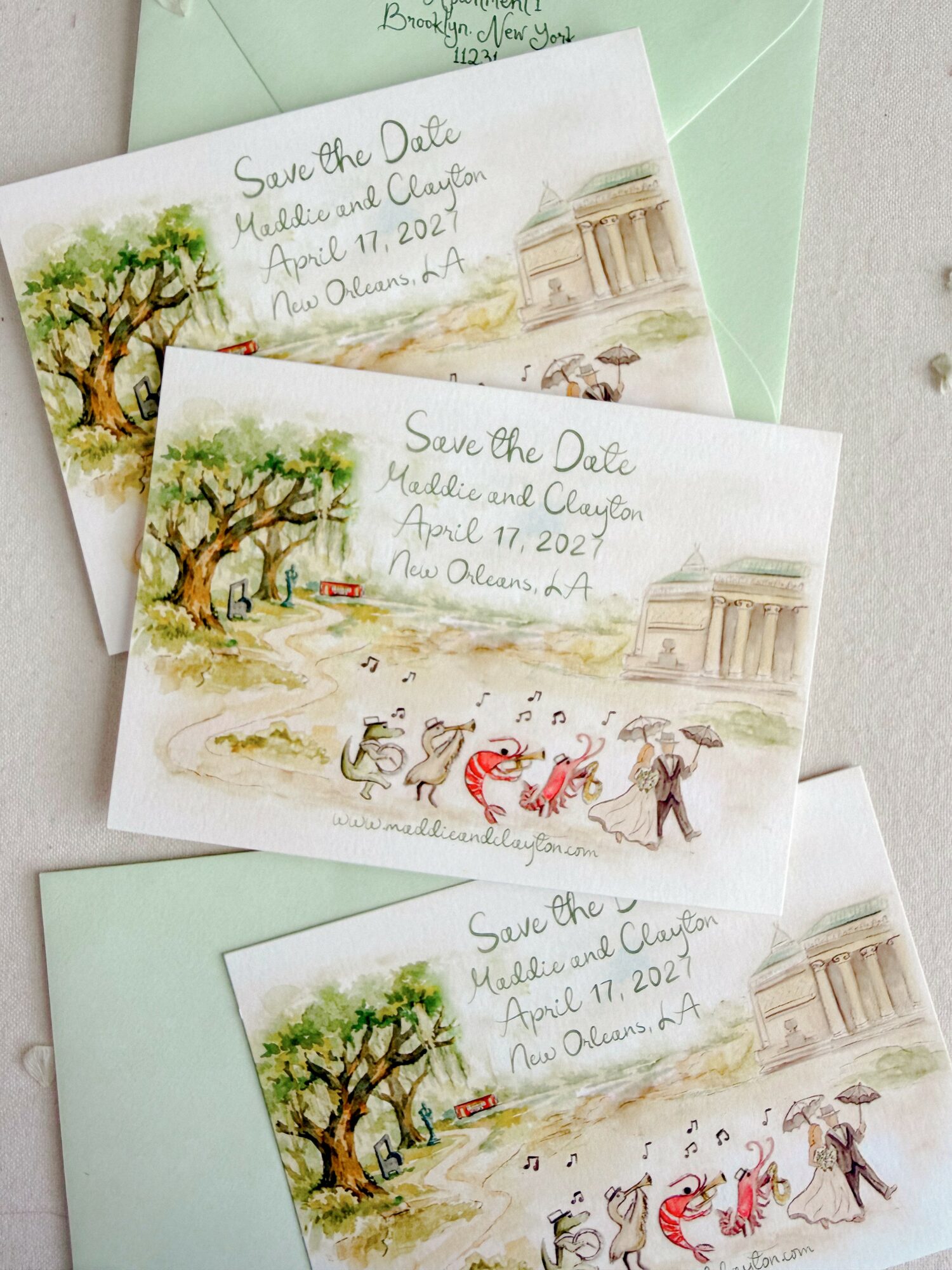 Three save-the-date cards with watercolor illustrations of trees, a horse-drawn carriage, and a building, with handwritten event details.