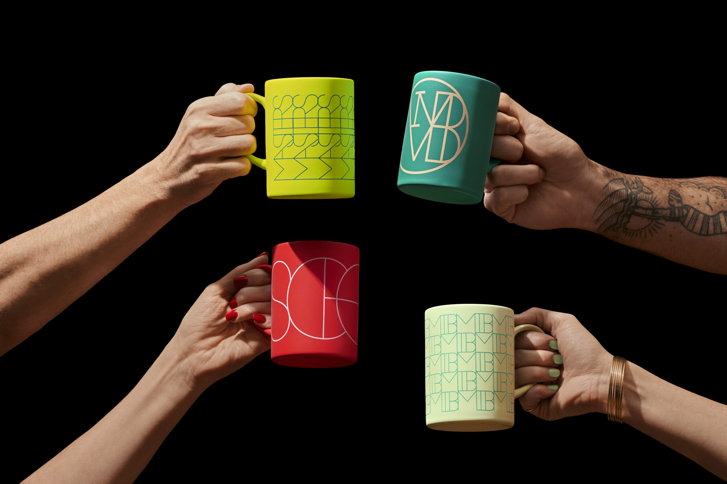 Four hands holding colorful mugs with abstract designs against a black background.