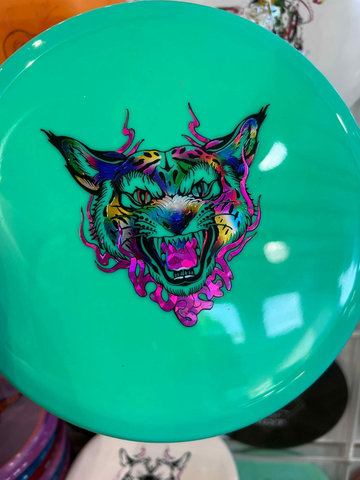 Balloon with a colorful tiger head illustration on a teal background.