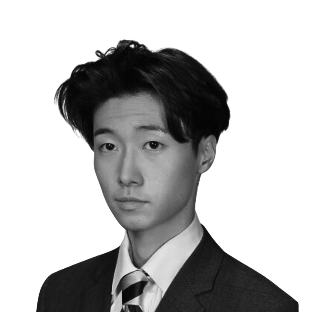 Black and white portrait of a young man in a suit and tie, facing forward with a neutral expression.