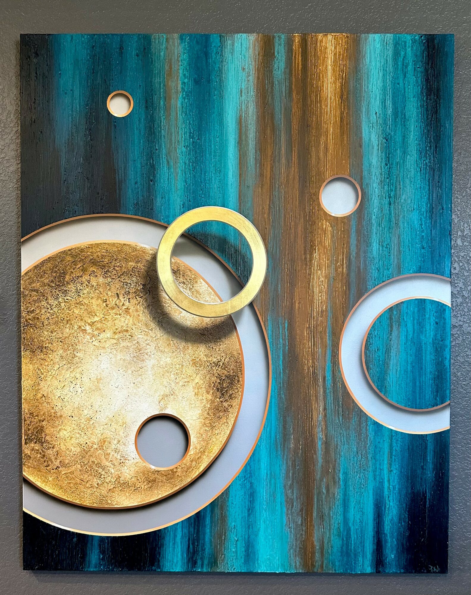 Abstract artwork with blue, gold, and white circular elements on a textured background.