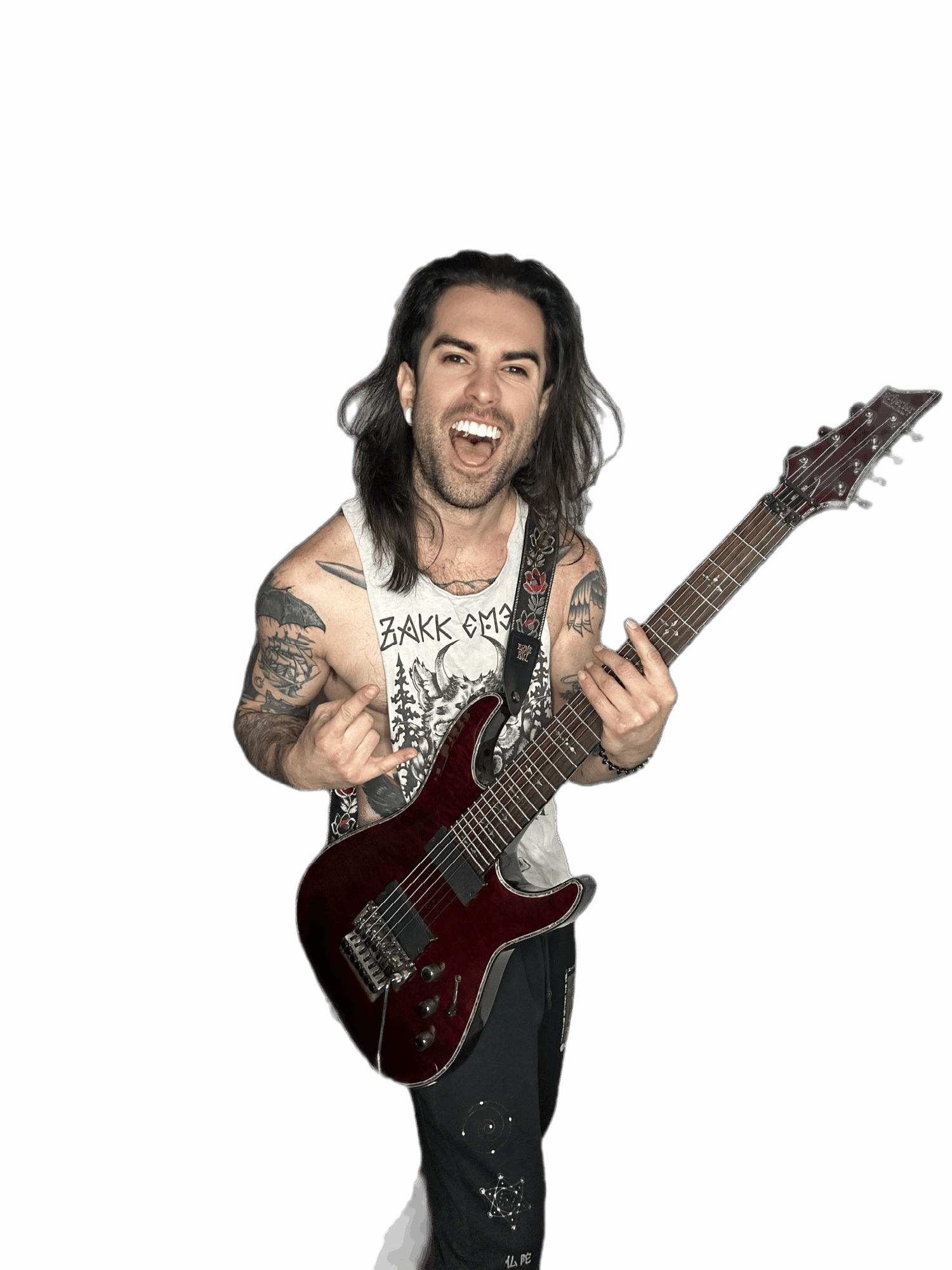 Person with long dark hair, tattoos, holding a guitar, smiling, against a black background.