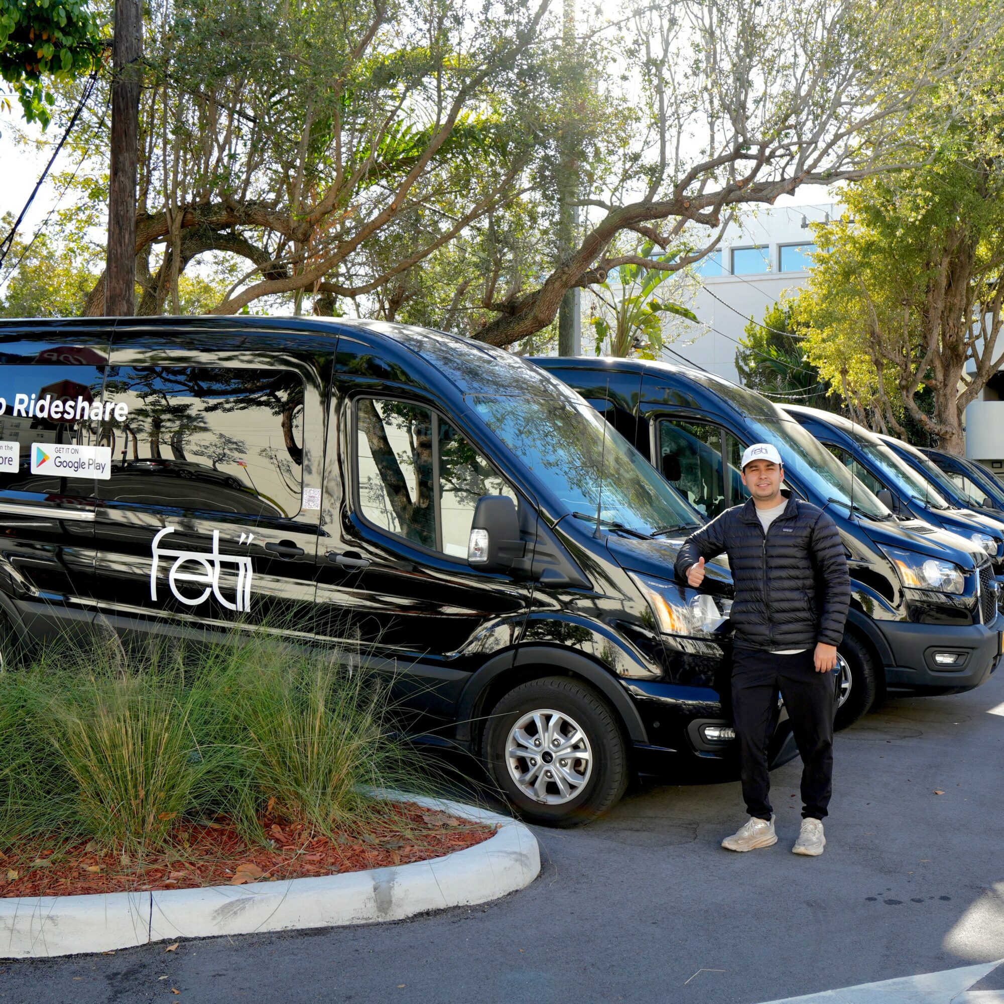 Person standing next to a black van with