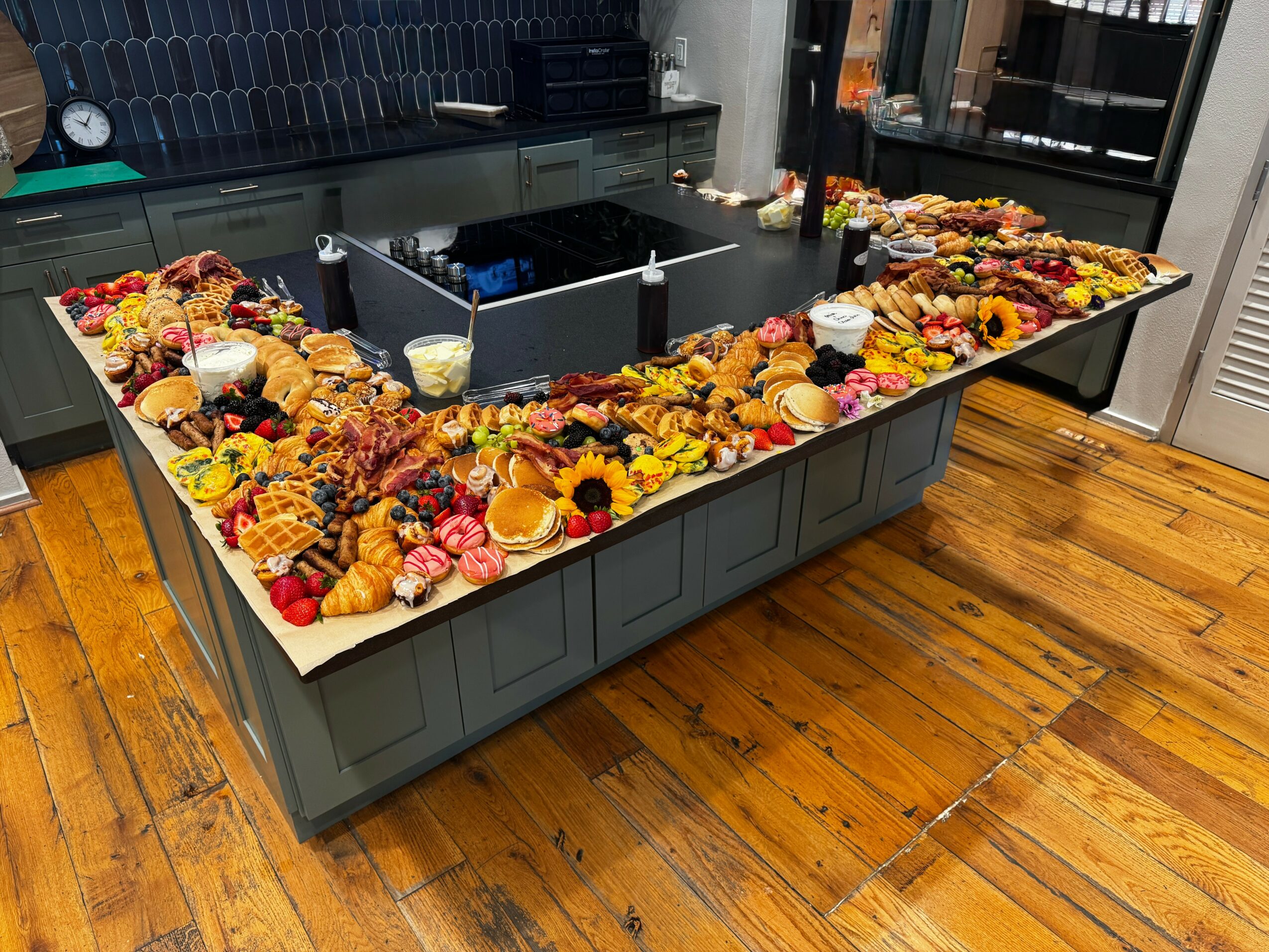 A kitchen island decorated with pumpkins, sunflowers, and fall-themed items, with a stove and cabinets in the background.