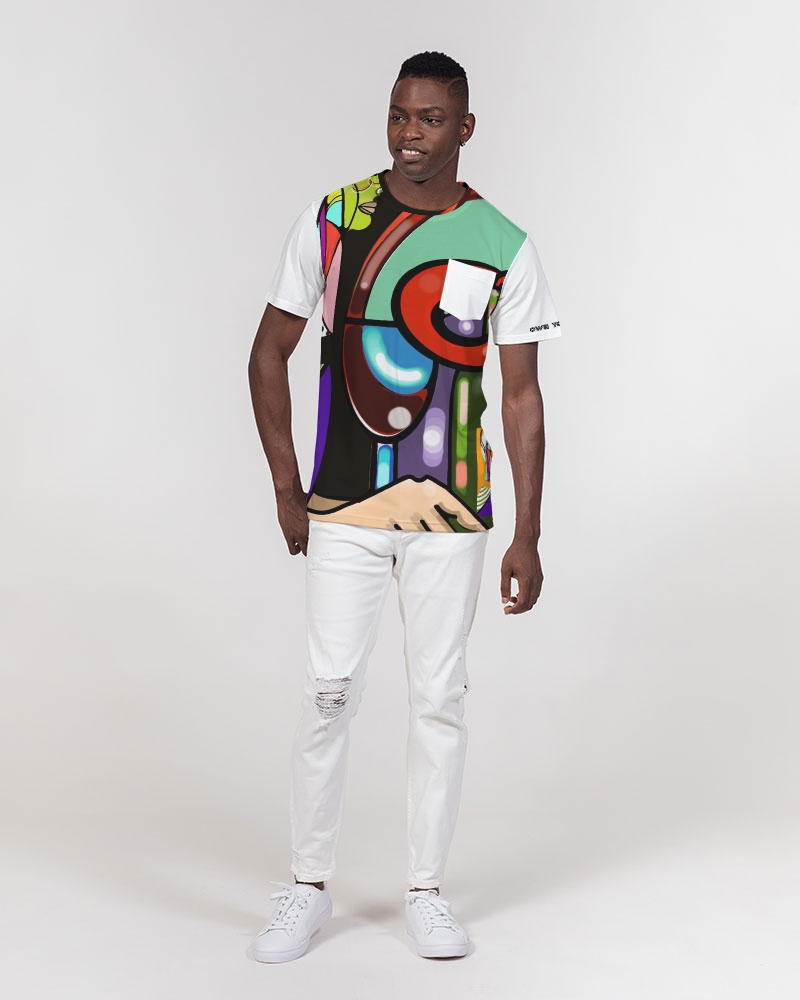 Young man standing against a plain background, wearing a colorful abstract patterned shirt and white pants, smiling.