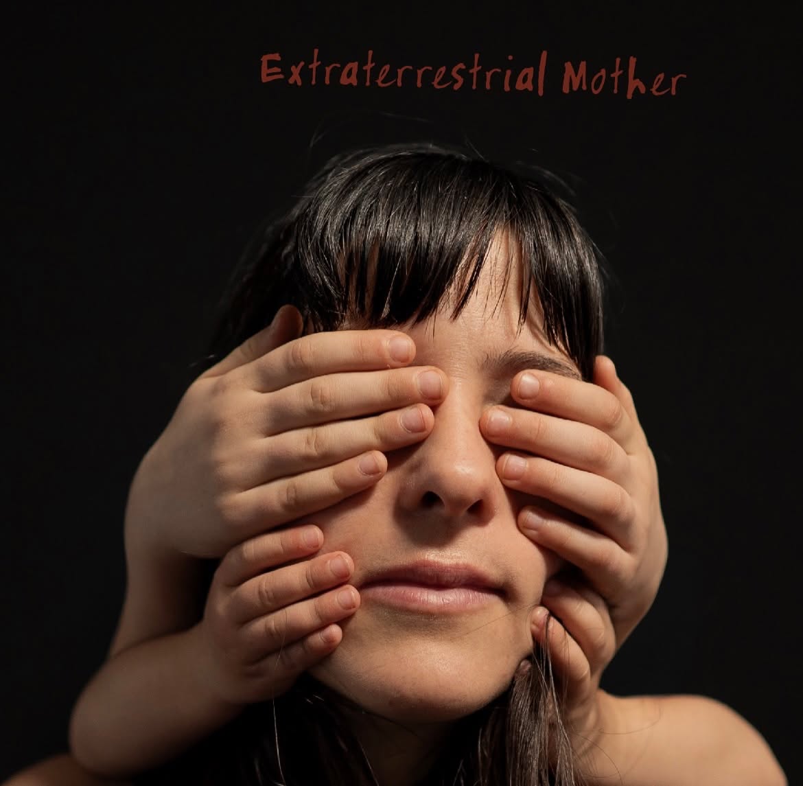 Person with eyes covered by hands, dark background, red text reading 'Extraterrestrial Mother' at top.