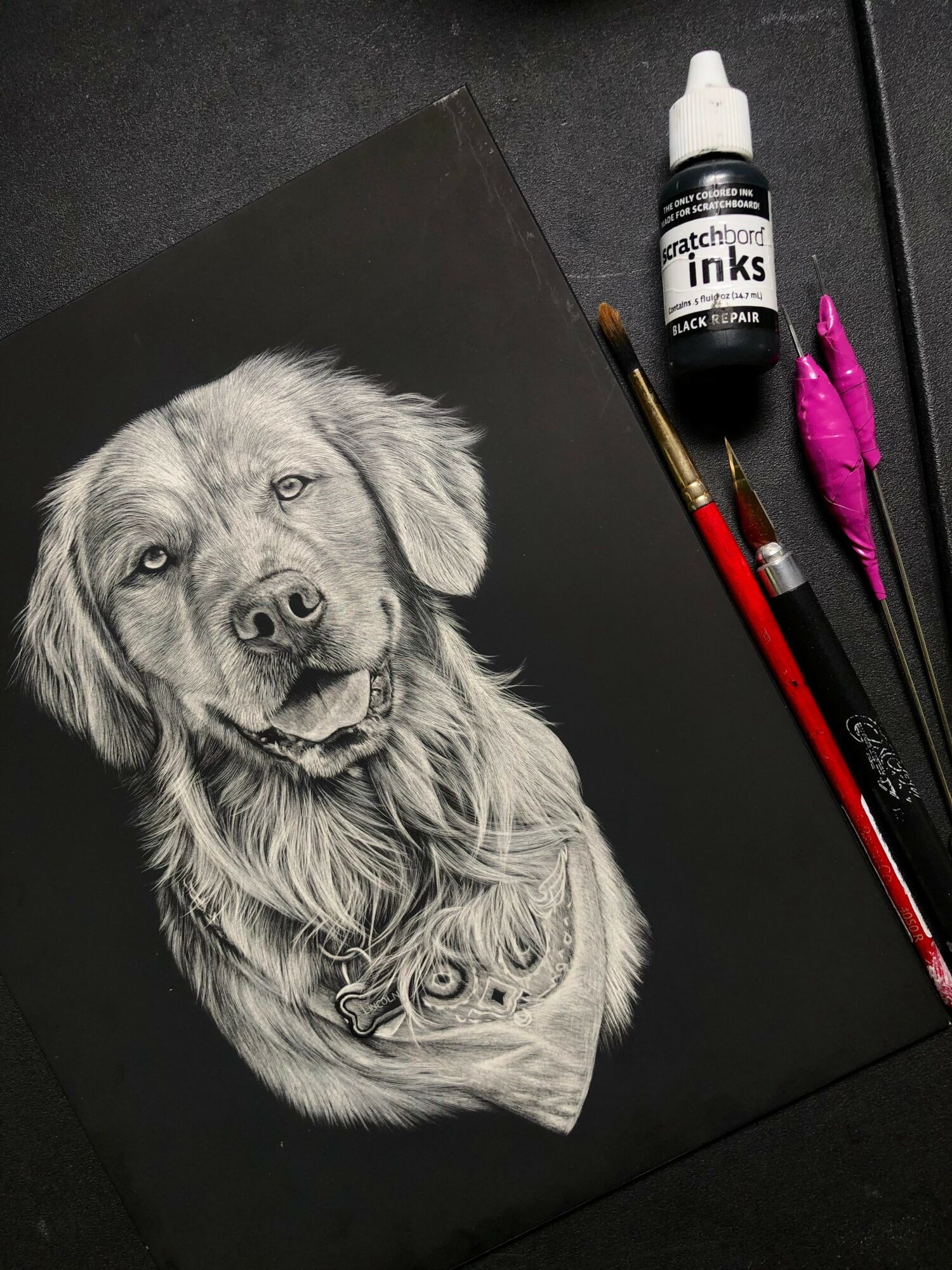 Black and white drawing of a dog with a happy expression, surrounded by art supplies including ink, brushes, and pens.