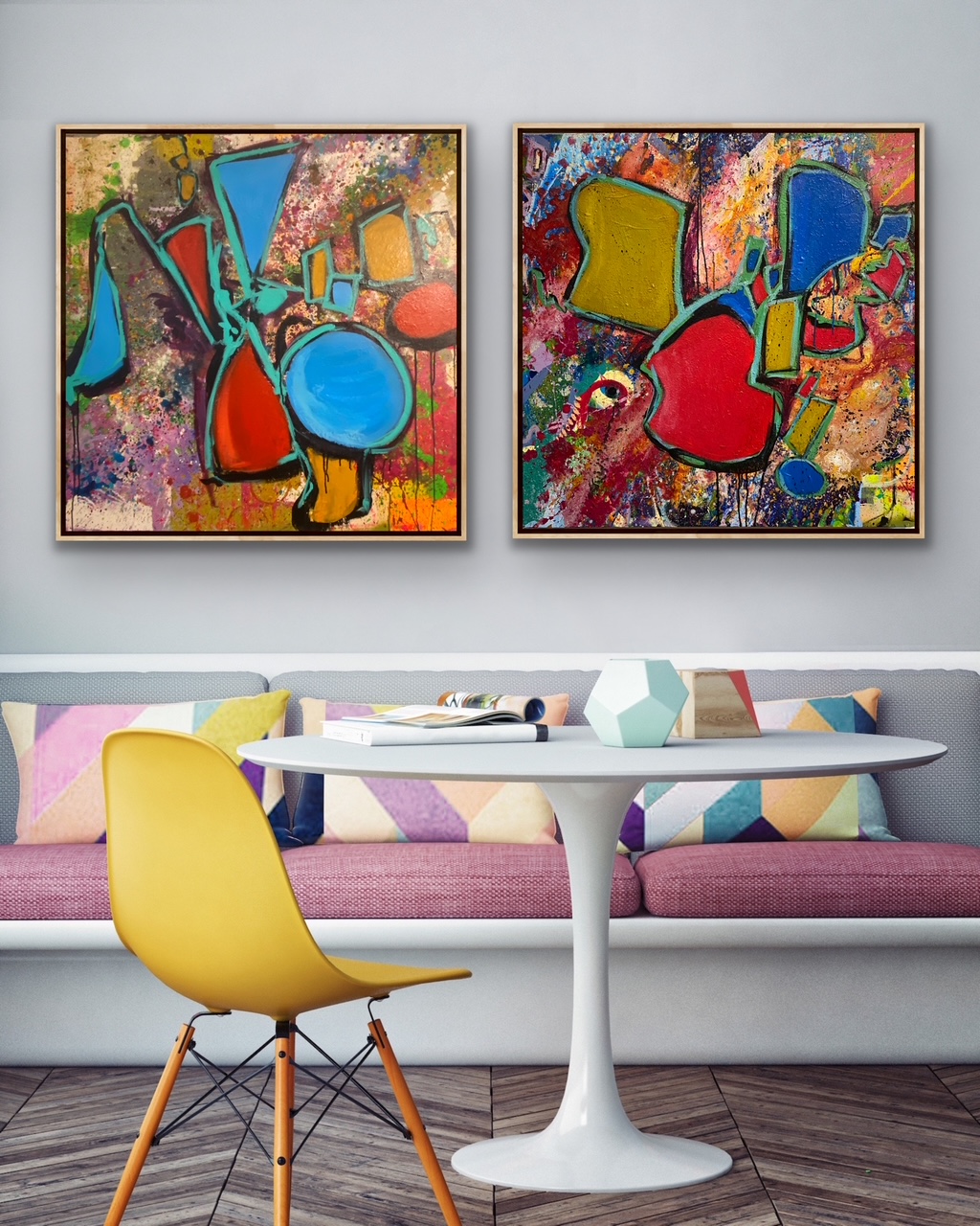 Two colorful abstract paintings hang above a sofa with multicolored pillows, a white table, and a yellow chair in a modern room.