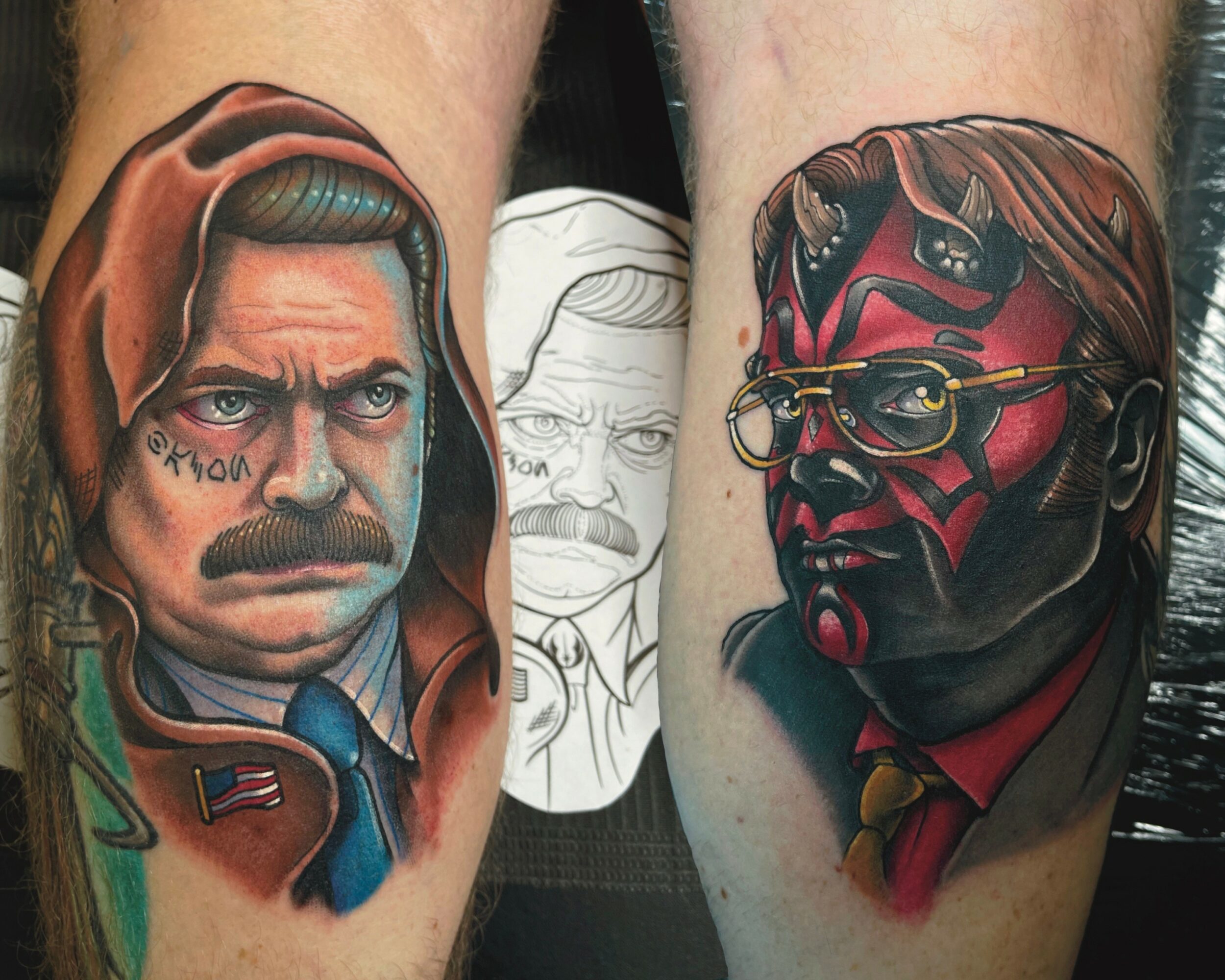 Two tattoos of faces, one with a hood and mustache, the other with glasses and a red face mask, on arms.