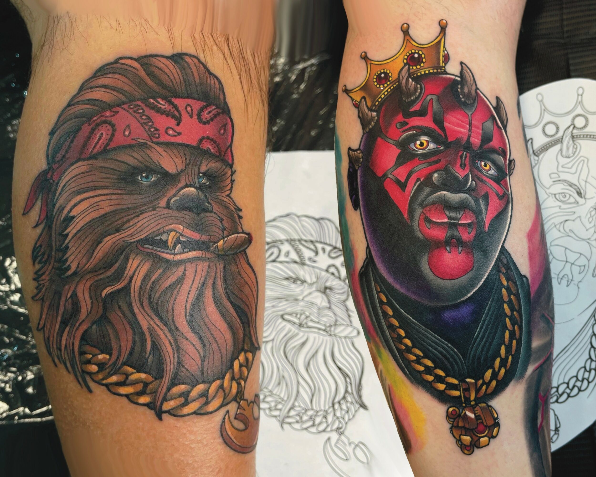 Two tattoos: one of a lion with a red bandana, and another of a red and black demon-like face with a crown and jewelry.