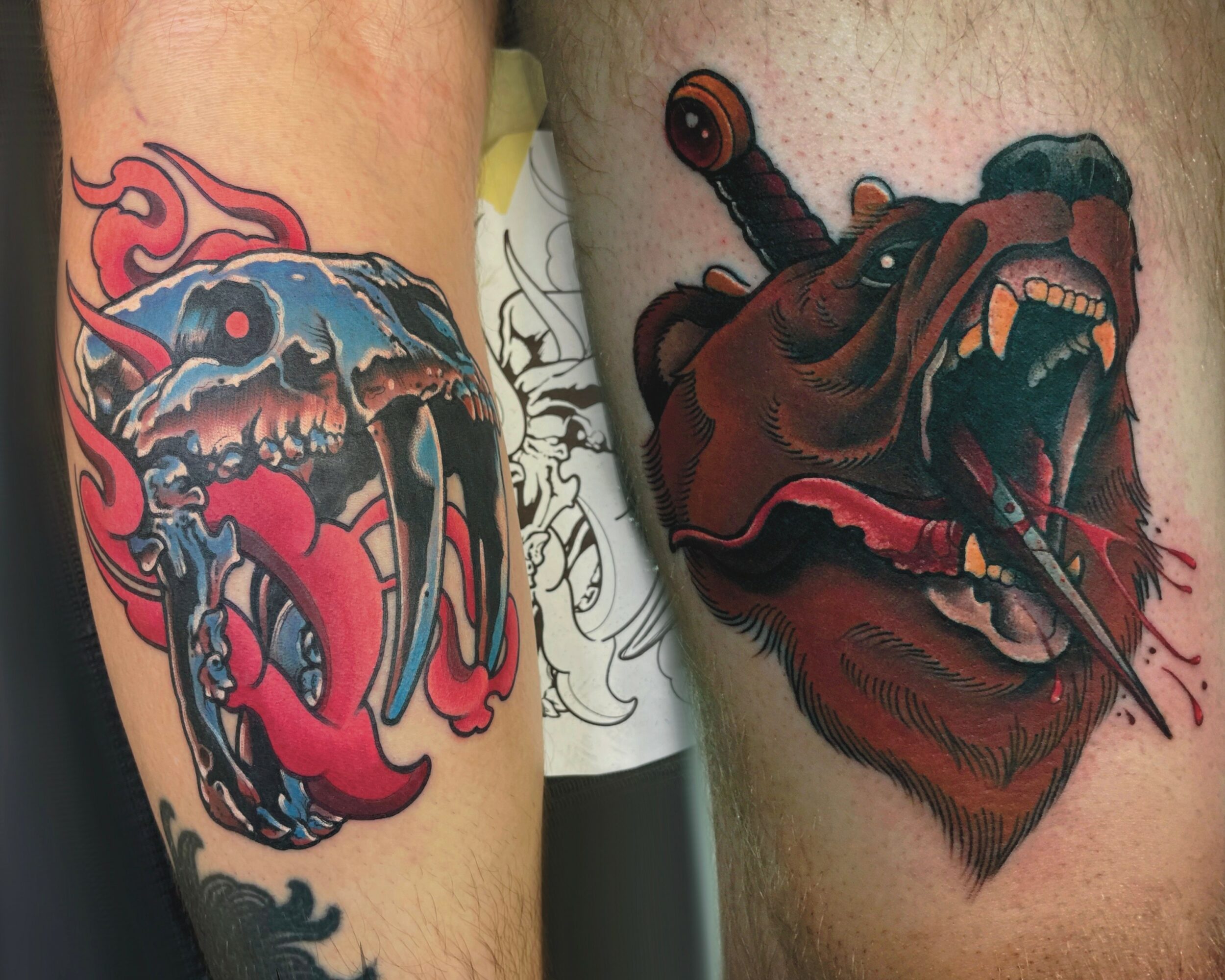 Two tattoos of animal heads with open mouths, one with flames and the other with a sword in its mouth.
