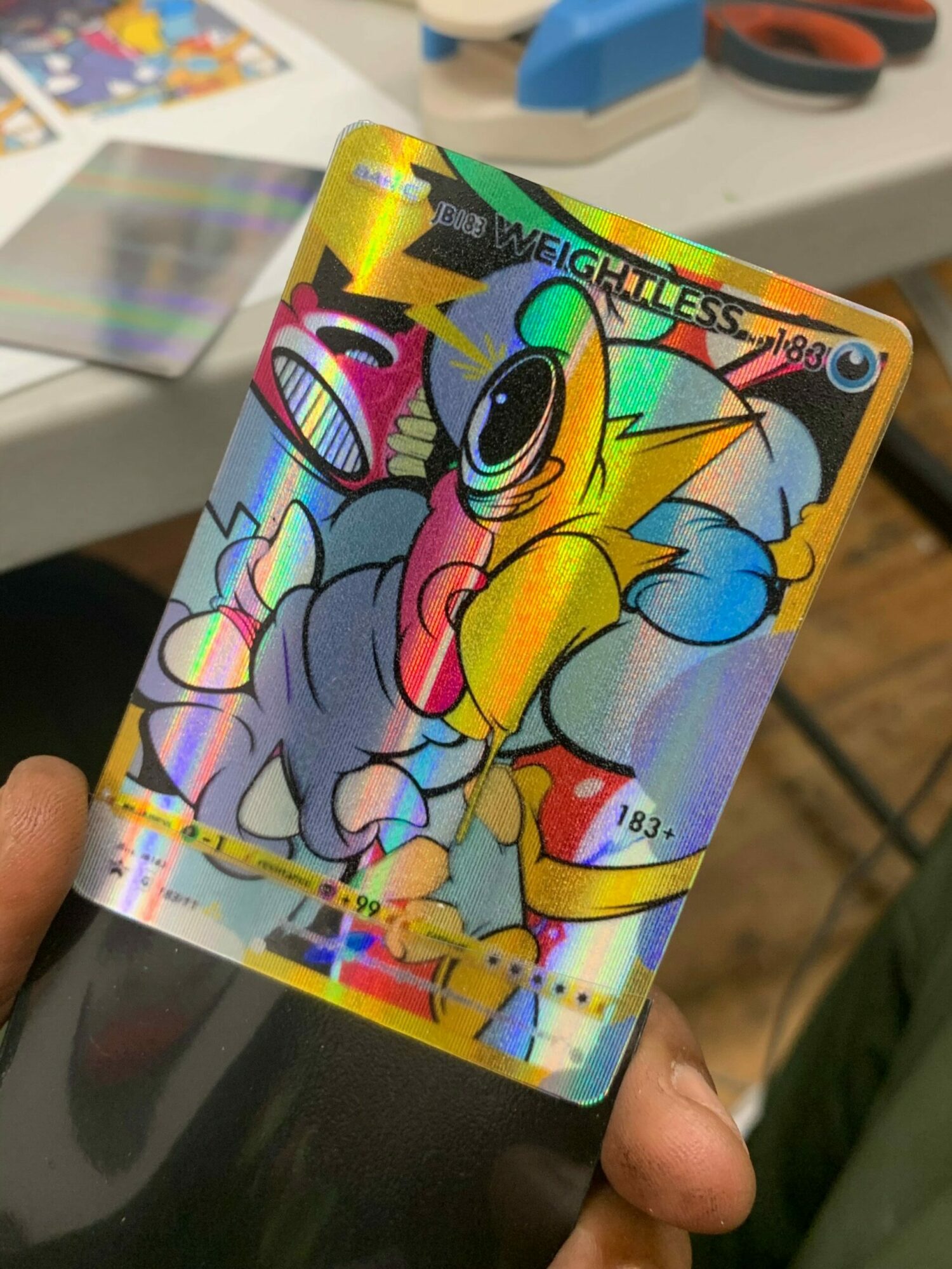 Holographic Pokémon card featuring Pikachu with a rainbow background and shiny effects.